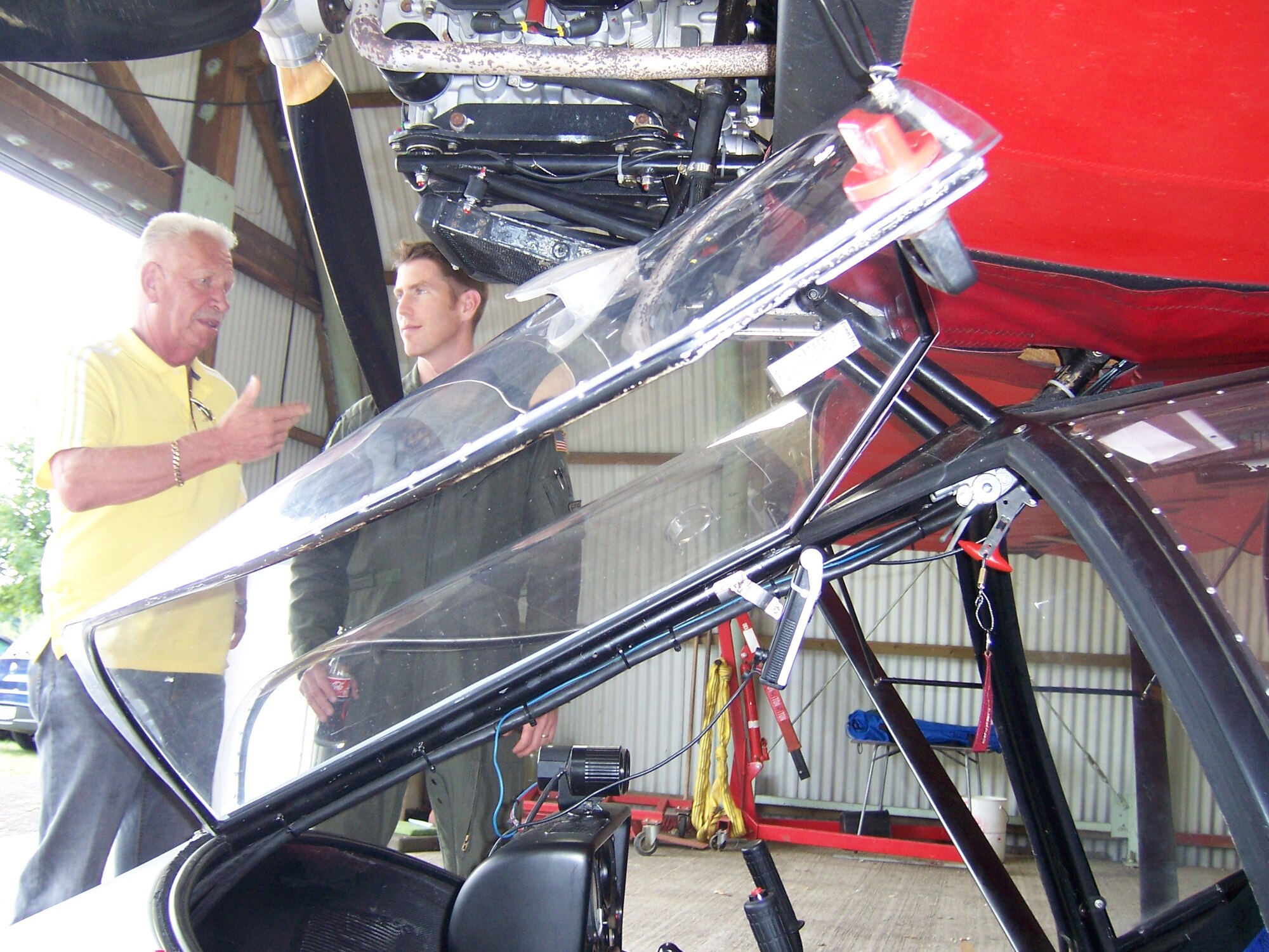 Bernie Kretschmar, Essweiler Glider Port ultralight pilot, discusses flying procedures with Capt. Kent Jensen, 86th Airlift Wing Safety office, Aug. 9 in Essweiler. (U.S. Air Force photo by Capt. Erin Dorrance)(Released)