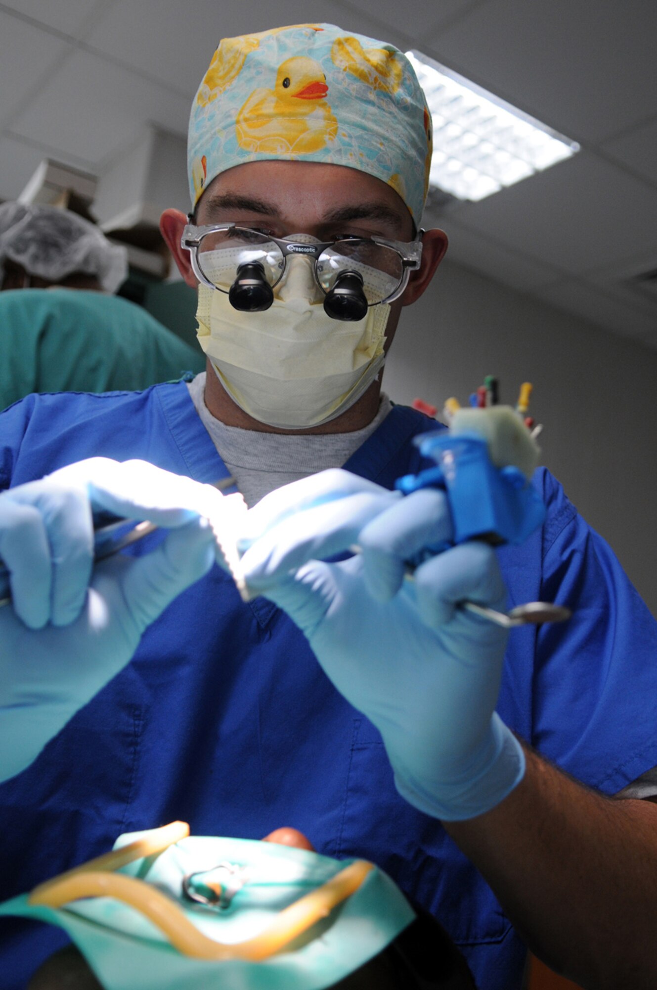 07/30/2008 - MANAS AIR BASE, KYRGYZ REPUBLIC -- Capt. Zachary Allmand, 376th Expeditionary Medical Group dentist, performs a root canal on a patient here, July 30, in the new medical facility. Captain Allmand provides dental care to more than 1,000 U.S. and coalition servicemembers deployed to Manas, as well as thousands more that transit in and out of Afghanistan daily. (Air Force photo / Airman 1st Class Ruth Holcomb)