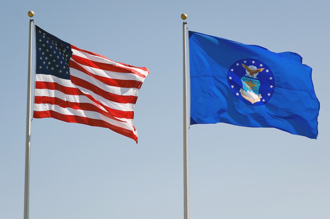 The American flag and the U.S. Air Force Flag fly over the ceremonial parade field on Bolling Air Force Base, Washington, D.C., during a welcoming ceremony for the 19th Air Force Chief of Staff Gen. Norton A. Schwartz, Aug. 12, 2008. 