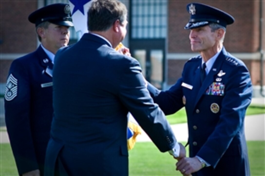 Acting Secretary of the Air Force Michael Donley passes the ceremonial flag to the 19th Air Force Chief of Staff Gen. Norton A. Schwartz during a welcoming ceremony for Schwartz on Bolling Air Force Base, Washington, D.C., Aug 12, 2008.