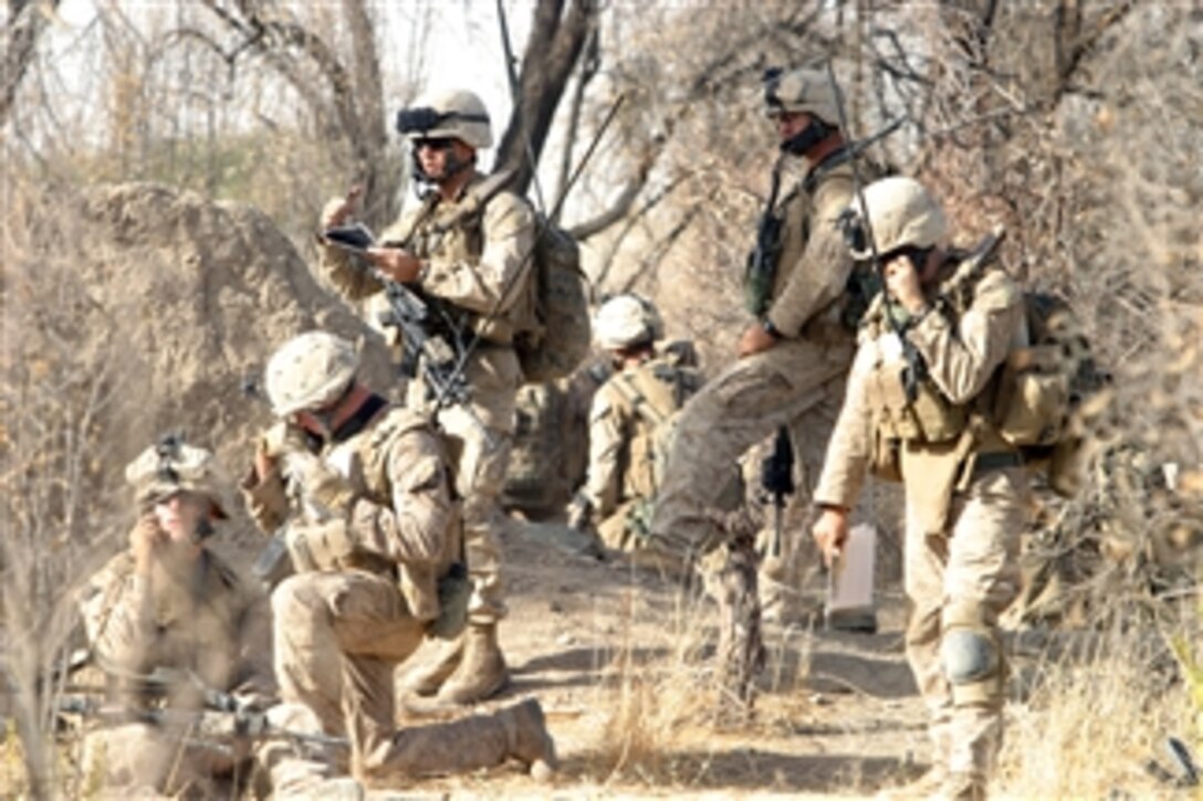 U.S. Marines communicate with their command operation center during a raid on a Taliban headquarters in Afghanistan on Aug. 1, 2008.  The Marines are from Foxtrot Company, 2nd Battalion, 7th Marine Regiment.  