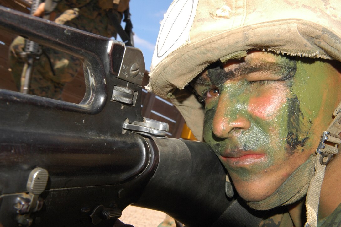 Recruit Andrew W. Goodwin sights in and provides security while his fellow recruits finish a Crucible exercise at Weapons and Field Training Battalion, Camp Pendleton, Calif., Aug. 12