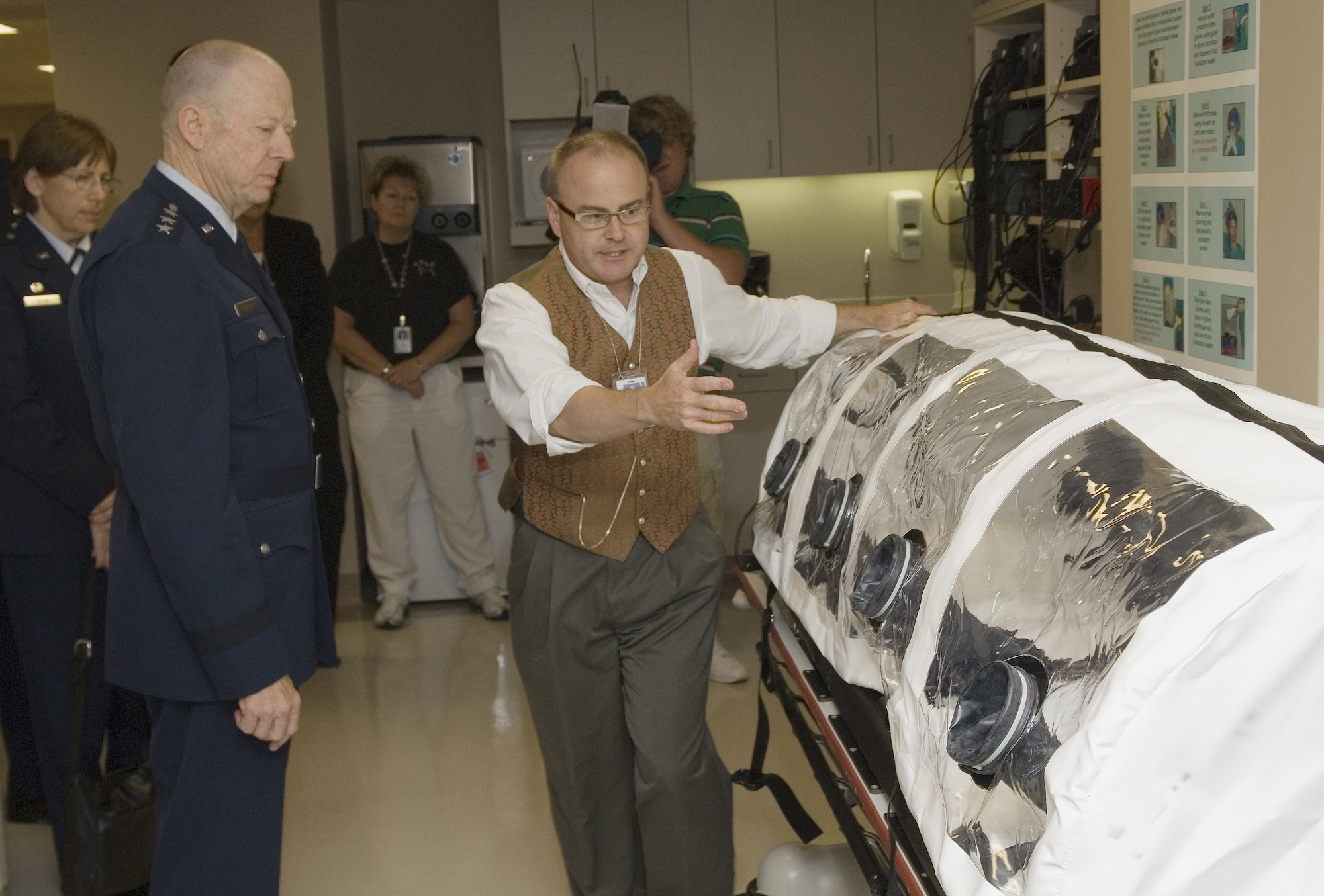 Frank Freihaut points out various features of an isolation pod that is used to transport patients safely through and into an isolation ward to Lt. Gen. (Dr.) James G. Roudebush during a tour of The Nebraska Medical Center’s Biocontainment Unit on the University of Nebraska Medical Center campus Aug. 13 in Omaha Neb. General Roudebush is a Nebraska native and is the Air Force surgeon general. Mr. Freihaut is a respiratory therapist. (U.S. Air Force photo/Lance Cheung)