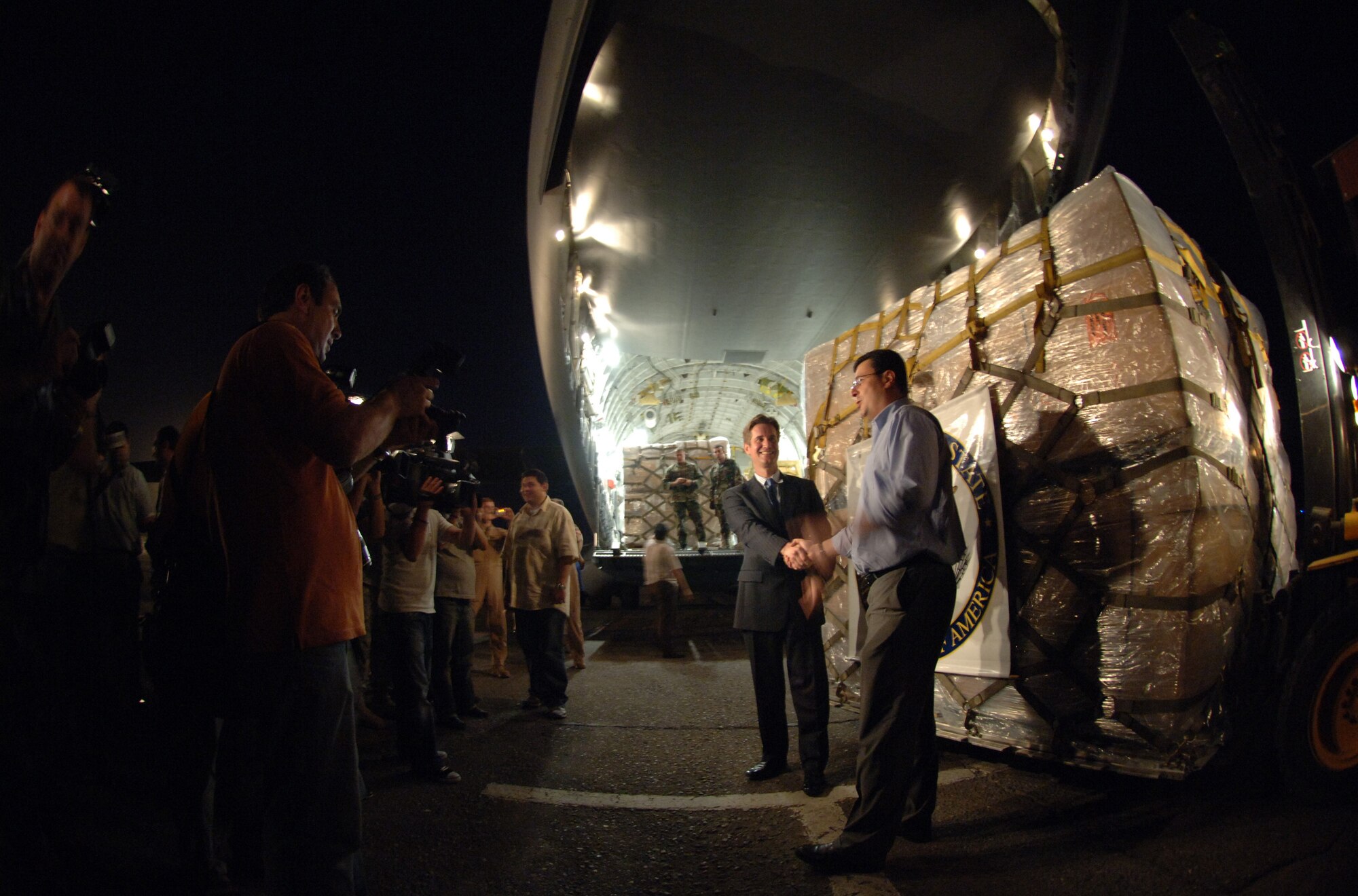 International press photograph U.S. State Department special envoy Matthew Bryza and a Georgian official who greeted the delivery of 16 pallets, containing $1 million in U.S. donated life support equipment and medical supplies for the people of the Republic of Georgia. The delivery was a joint-service effort between U.S Army Europe Soldiers and Airmen representing U.S. Air Forces in Europe and Air Mobility Command. (U.S. Air Force photo/Master Sgt. Scott Wagers)