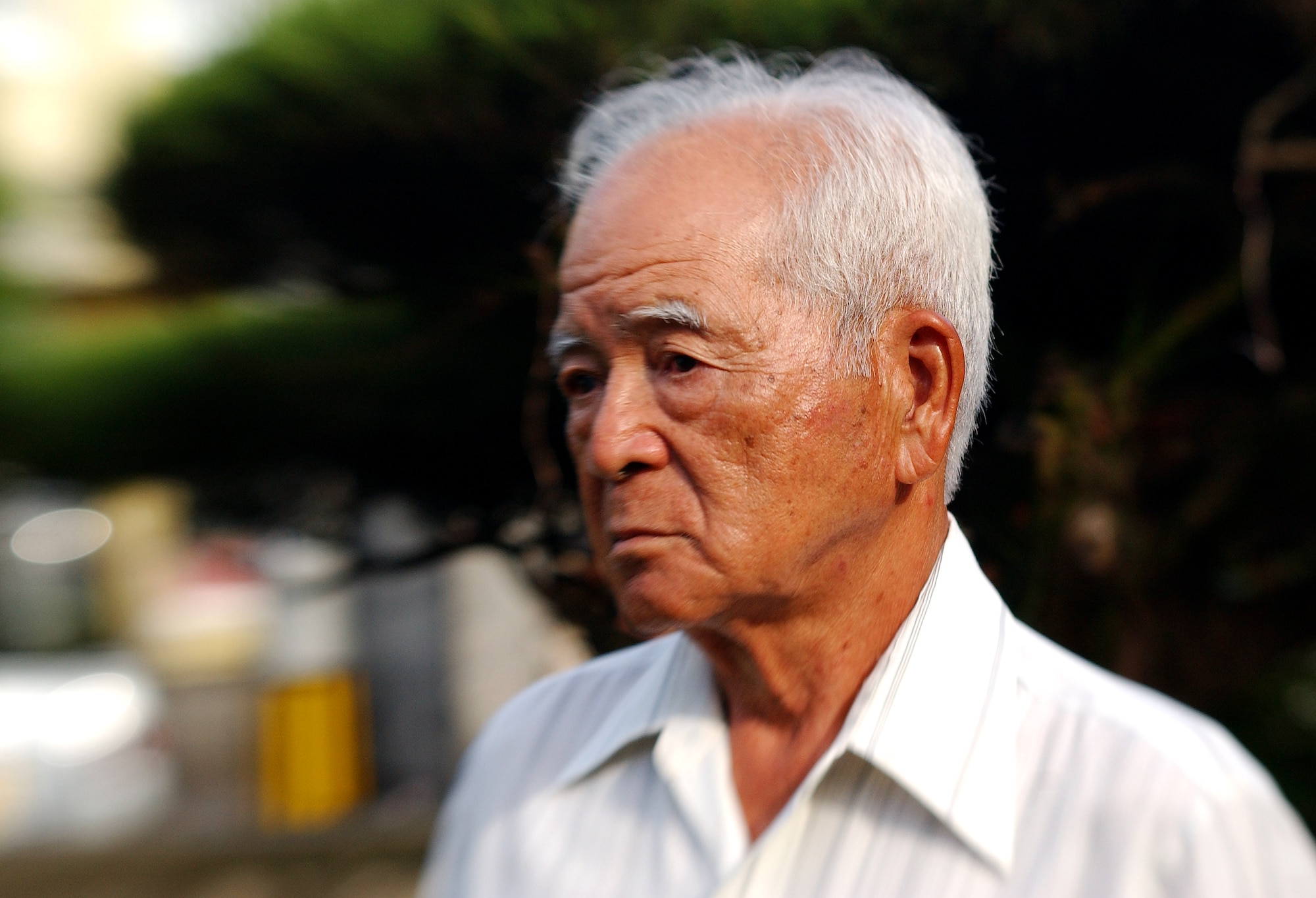 Mr. Eiichiro Shimabukuro, 77 years old, recalls the aftermath of World War II when the U.S. military worked with Okinawans to rebuild the island's devastated infrastructure and return life to normalcy, during an interview August 12. Mr Shimabukuro has worked and volunteered at the Kadena clinic since 1950 and was the first Okinawan hired to work there. (U.S. Air Force photo/Tech. Sgt. Rey Ramon)