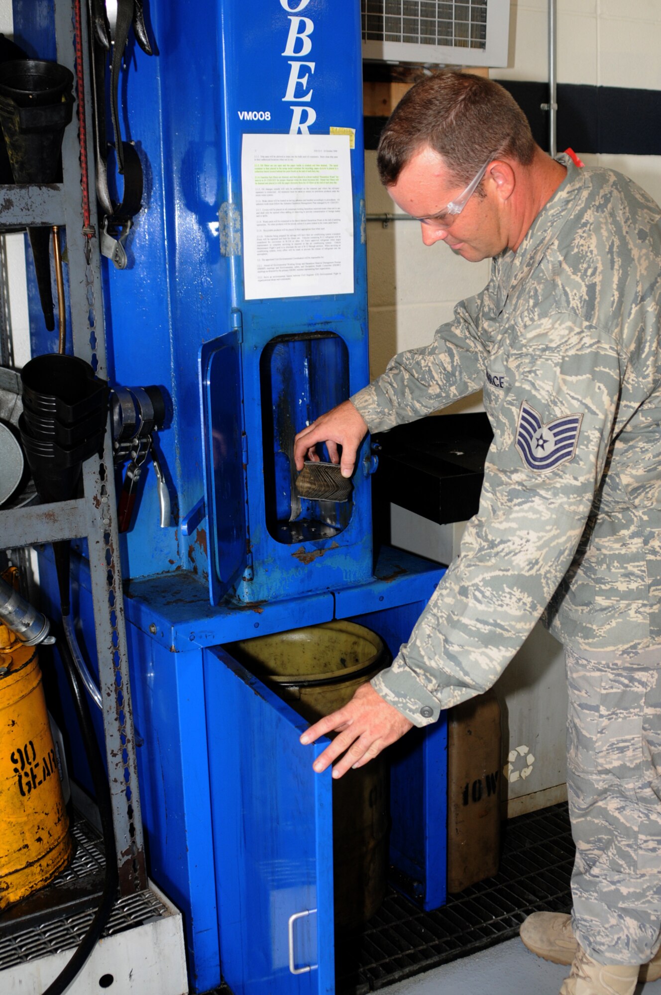 Tech. Sgt. Steven Lyonnais, 81st SUPS-TRANS, crushes oil filters for recycling.  (U.S. Air Force photo by Kemberly Groue)