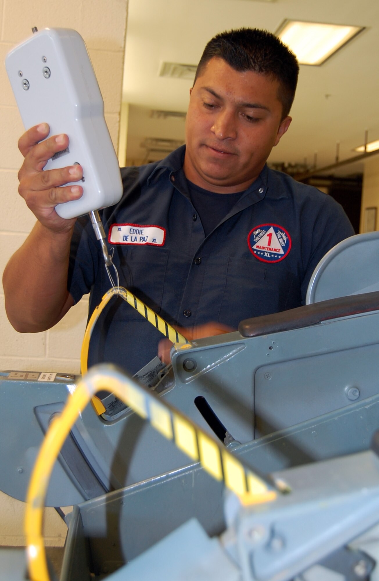 LAUGHLIN AIR FORCE BASE, Texas-- Eddie De La Paz performs pull-check inspection before repairing the ejection seat of a T-38 at the Egress shop here Aug. 7.  De La Paz is a member of the 47th Maintenance Directorate’s Aircraft Ordnance Systems shop.  Members of the shop are responsible for performing maintenance work on aircraft ejection seats. They are also responsible for maintaining complete emergency escape systems, such as ejection seats, escape hatches and capsules, used by flight personnel to escape disabled aircraft.  (U.S. Air Force photo/Staff Sgt. Olufemi A. Owolabi)