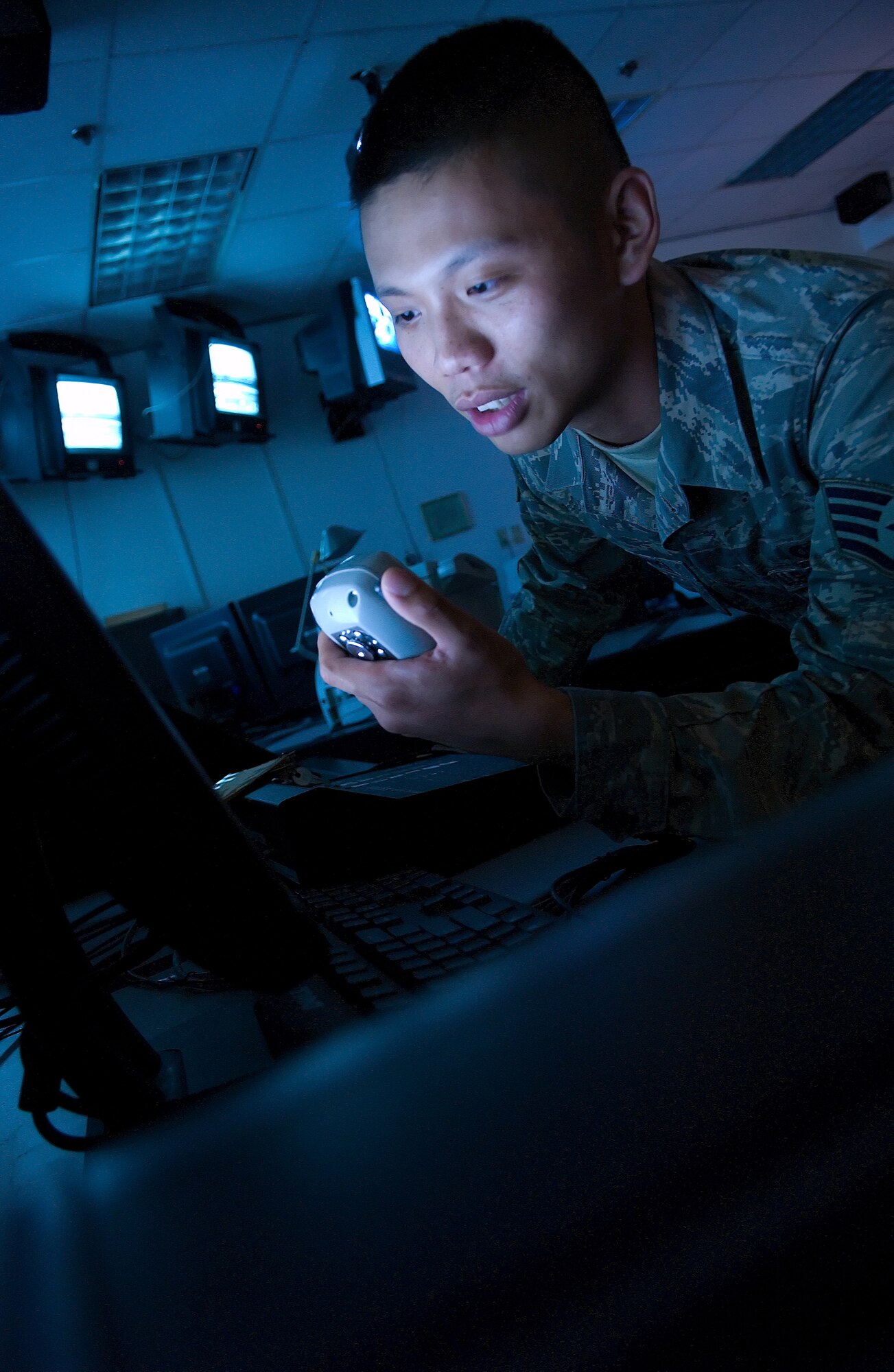 DOVER AIR FORCE BASE, Del. -- Staff Sgt. Alman Chiang, 436th AW Command Post controller, tests the base Giant Voice system Aug. 12 to ensure the equipment is mission ready. Operating the Giant Voice system is only one aspect of a controller’s diverse job. (U.S. Air Force photo/ Jason Minto)