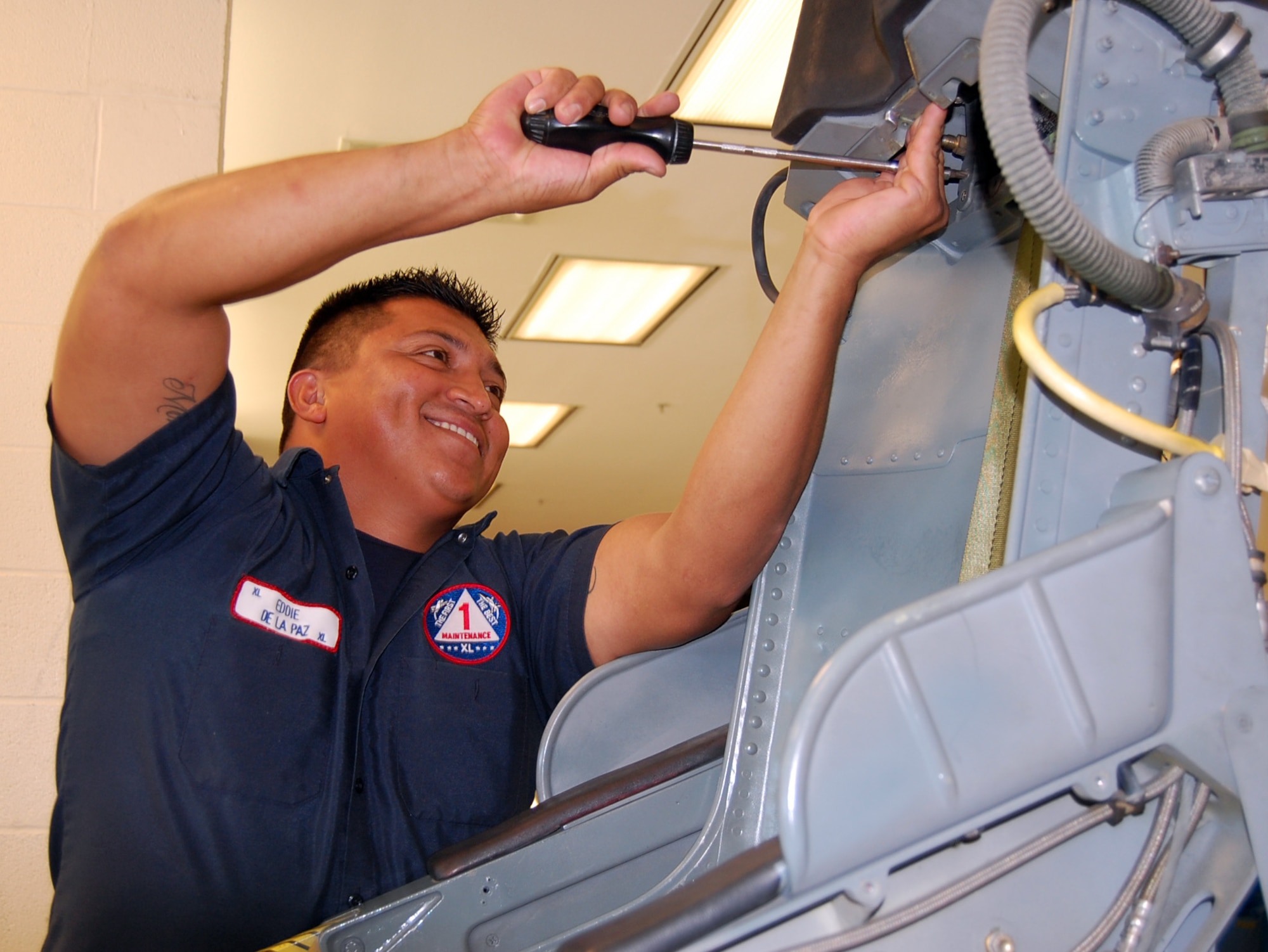 LAUGHLIN AIR FORCE BASE, Texas-- Eddie De La Paz repairs the ejection seat of a T-38 at the Egress shop here Aug. 7.  De La Paz is a member of the 47th Maintenance Directorate’s Aircraft Ordnance Systems shop.  Members of the shop are responsible for performing maintenance work on aircraft ejection seats. They are also responsible for maintaining complete emergency escape systems, such as ejection seats, escape hatches and capsules, used by flight personnel to escape disabled aircraft.  (U.S. Air Force photo/Staff Sgt. Olufemi A. Owolabi)