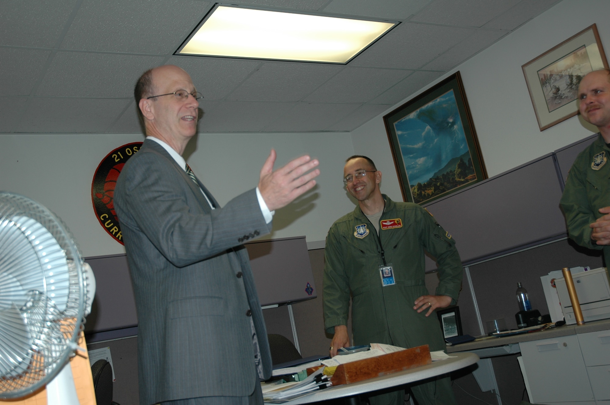Master Sgt. Gerd Scheller (right) talks with Mark Doboga, Headquarters, Air Force on how additional duties and various training requirements hamper his ability to perform his mission. Mr. Doboga and his six-man Headquarters, Air Force team are visiting several Air Force installations throughout the globe as they address concerns from commanders on what challenges they face concerning additional workloads and their programs. Mr. Doboga is a member of the Senior Executive Staff and is the director of Plans and Integration and the Air Force Personnel Operations Agency, as well as the Air Force’s Manpower and Personnel deputy chief of staff. Sergeant Scheller is the 21st Operations Support Squadron Non-commissioned Officer in Charge of Weapons and Tactics. (U.S. Air Force photo/Senior Airman Stephen Collier)
