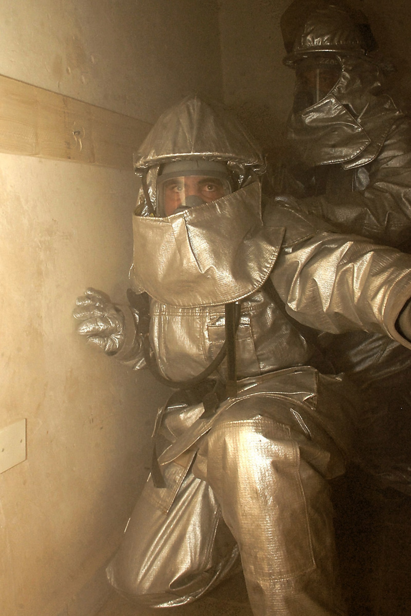 Iraqi firefighters traverse a smoky room during refresher training within confined spaces July 30, 2008, at Kirkuk Regional Air Base, Iraq. Firefighters with the 506th Expeditionary Civil Engineer Squadron facilitated the training to teach Iraqi firefighters how to rescue victims trapped in a building burning. (U.S. Air Force photo/Senior Airman Randi Flaugh)