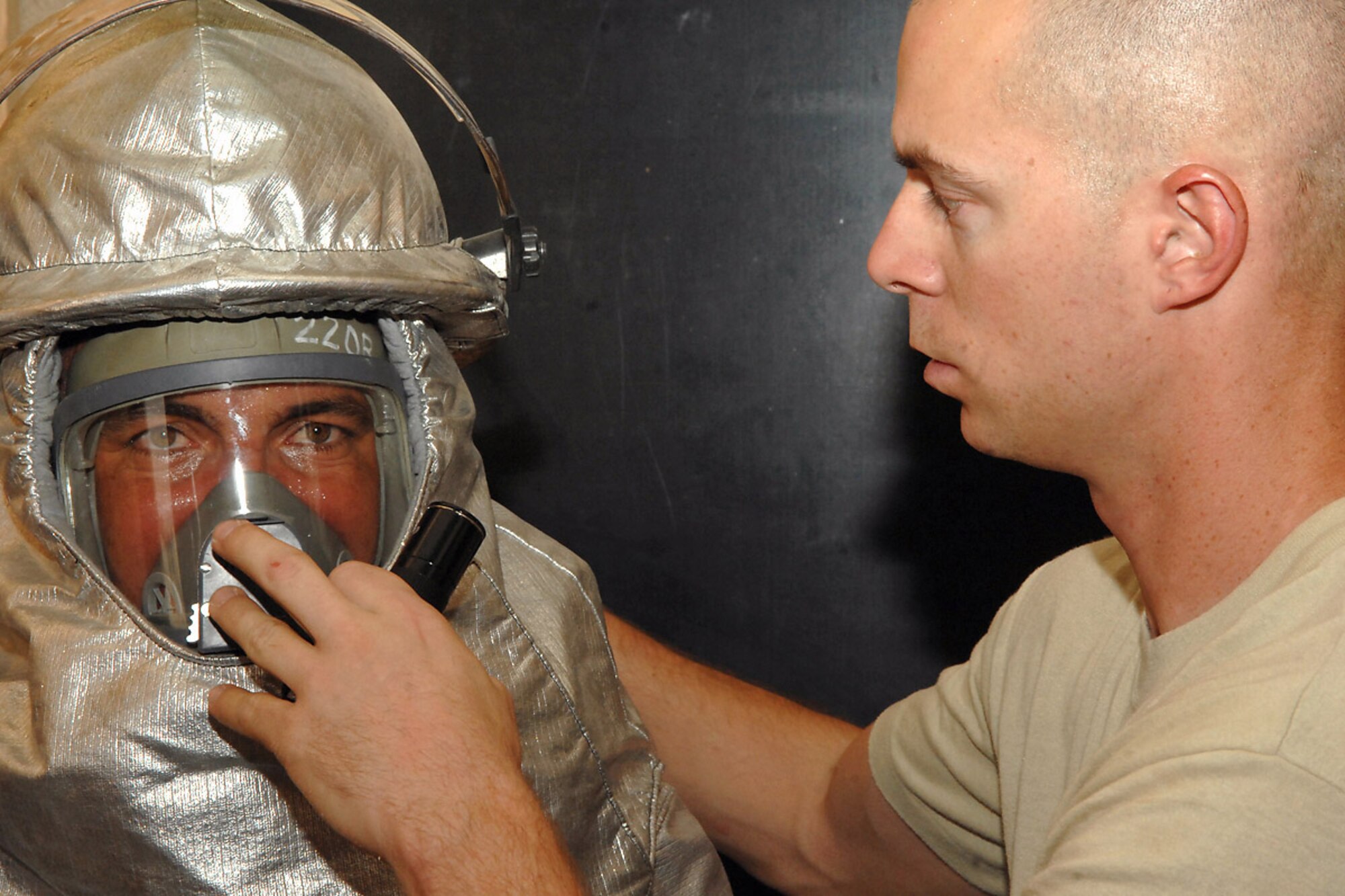 Staff Sgt. Craig Cusenz ensures an Iraqi firefighter can breathe using a self-contained breathing apparatus during combined American and Iraqi firefighter training July 30, 2008, at Kirkuk Regional Air Base, Iraq. Firefighters with the 506th Expeditionary Civil Engineer Squadron facilitated the training to teach Iraqi firefighters how to rescue victims trapped inside a burning building. Sergeant Cusenz, a firefighter with the 506th ECES, is a deployed reservist from Tinker Air Force Base, Okla. (U.S. Air Force photo/Senior Airman Randi Flaugh)