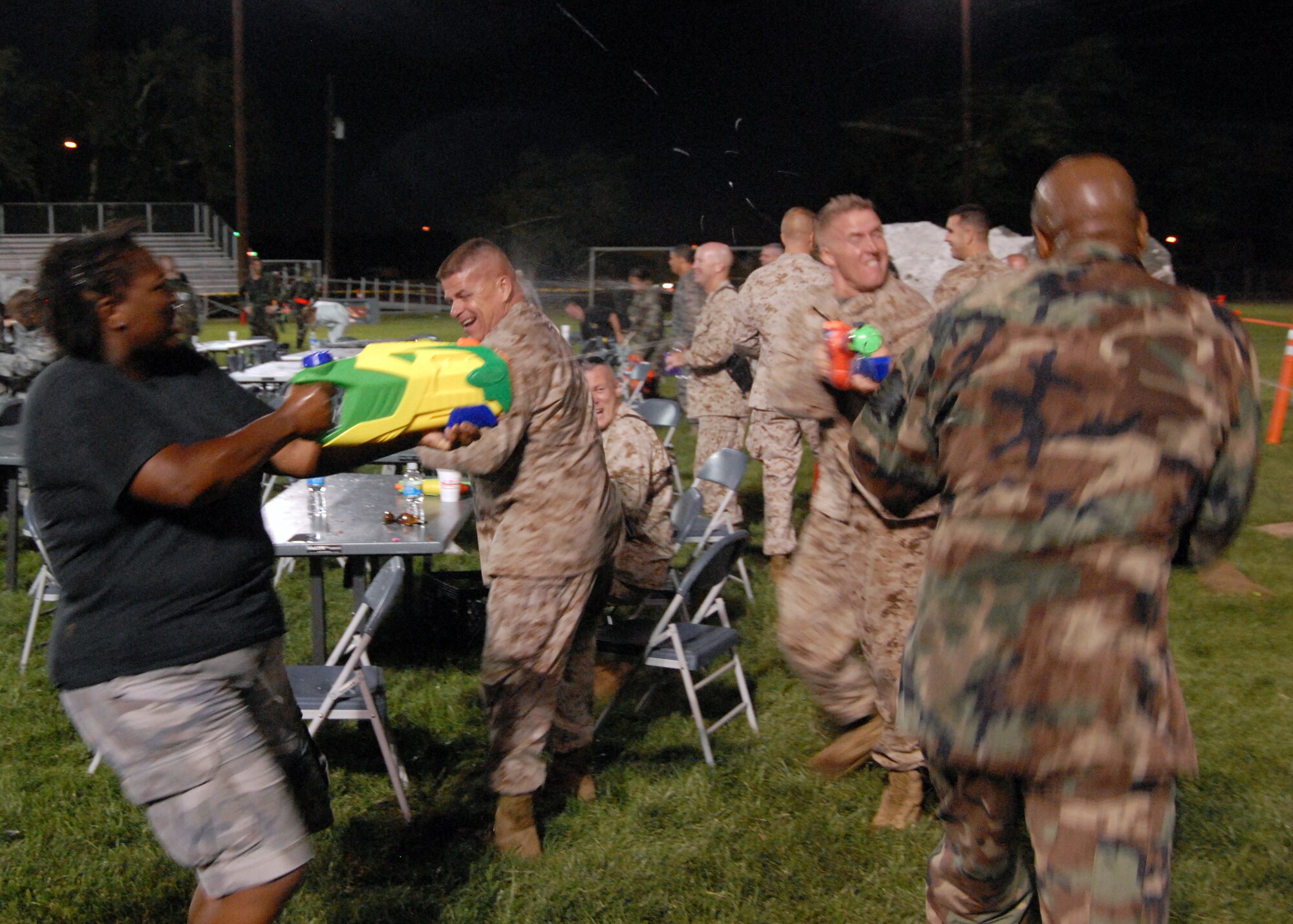 Team Edwards engage in combat during a combat dining out at Arnold Park Aug. 8. A combat dining out is a formal military function that brings together units from across the base in an attempt to build camaraderie and social networking. (Air Force photo by Airman 1st Class William O'Brien)