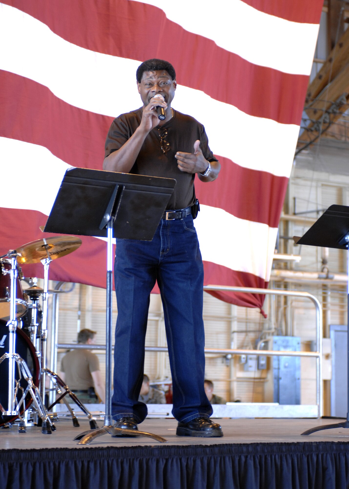 Mr. James "DJ Hale" Hale, 49th Logistics Readiness Squadron, sings Aug. 7 at the Hail and Farewell in Hangar 301 at Holloman Air Force Base, N.M. (U.S. Air Force photo/Airman 1st Class Rachel A. Kocin)