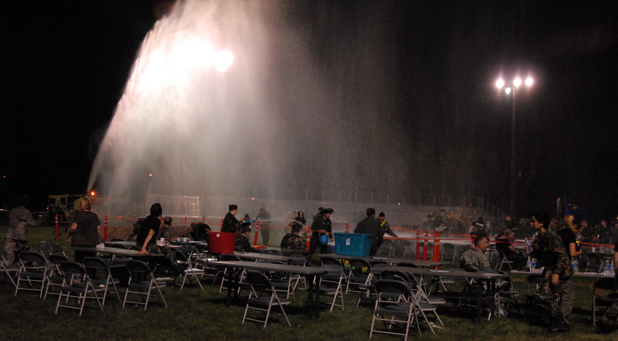 Firefighters combat "hostile" elements during the Team Edwards Combat Dining Out at Arnold Park Aug. 8. (Air Force photo by Senior Airman Julius Delos Reyes)