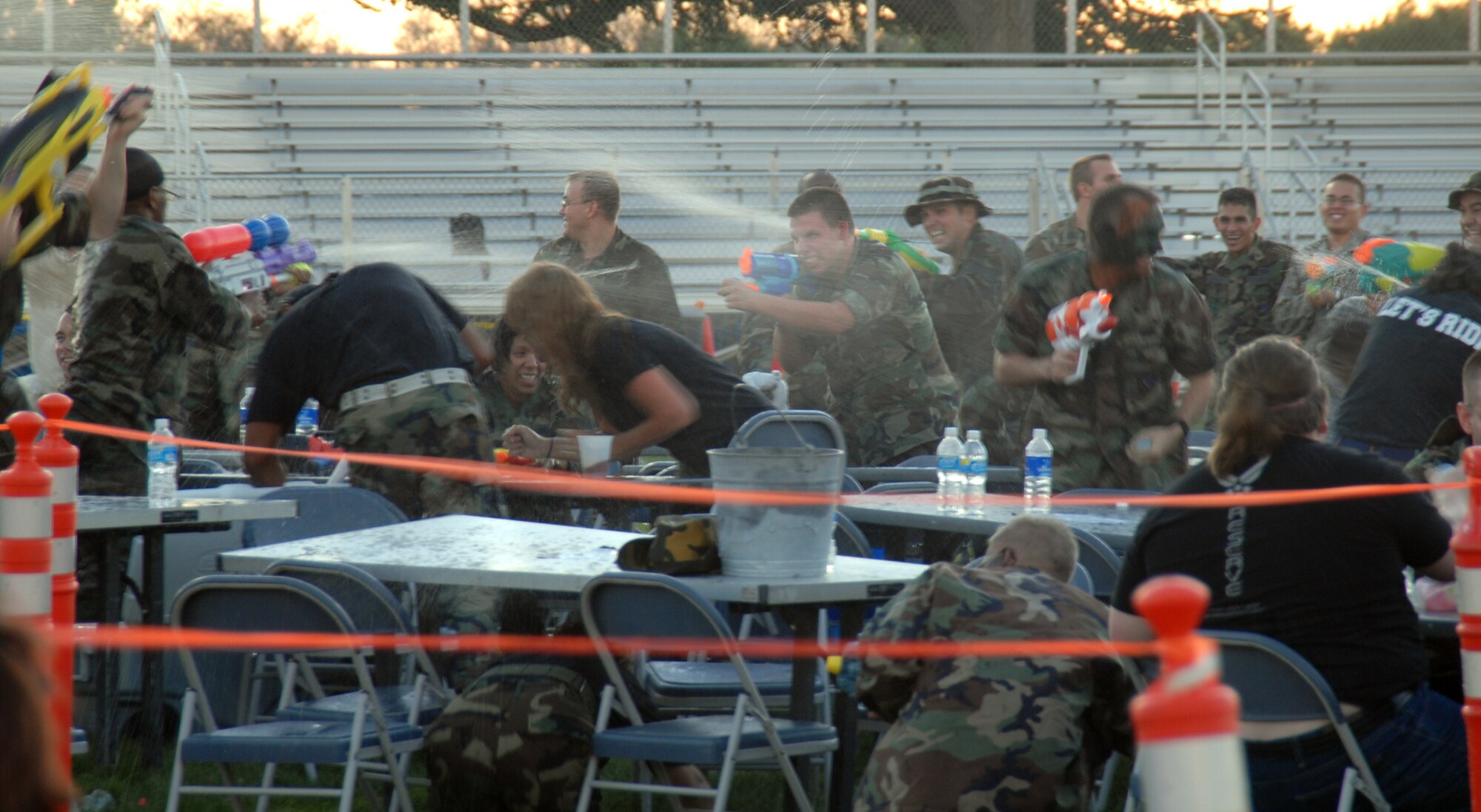 Team Edwards engage in water combat during the Team Edwards Combat Dining Out at Arnold Park on Aug. 8. More than 350 Airmen, Marines and civilians participated in the event. (Air Force photo by Senior Airman Julius Delos Reyes)