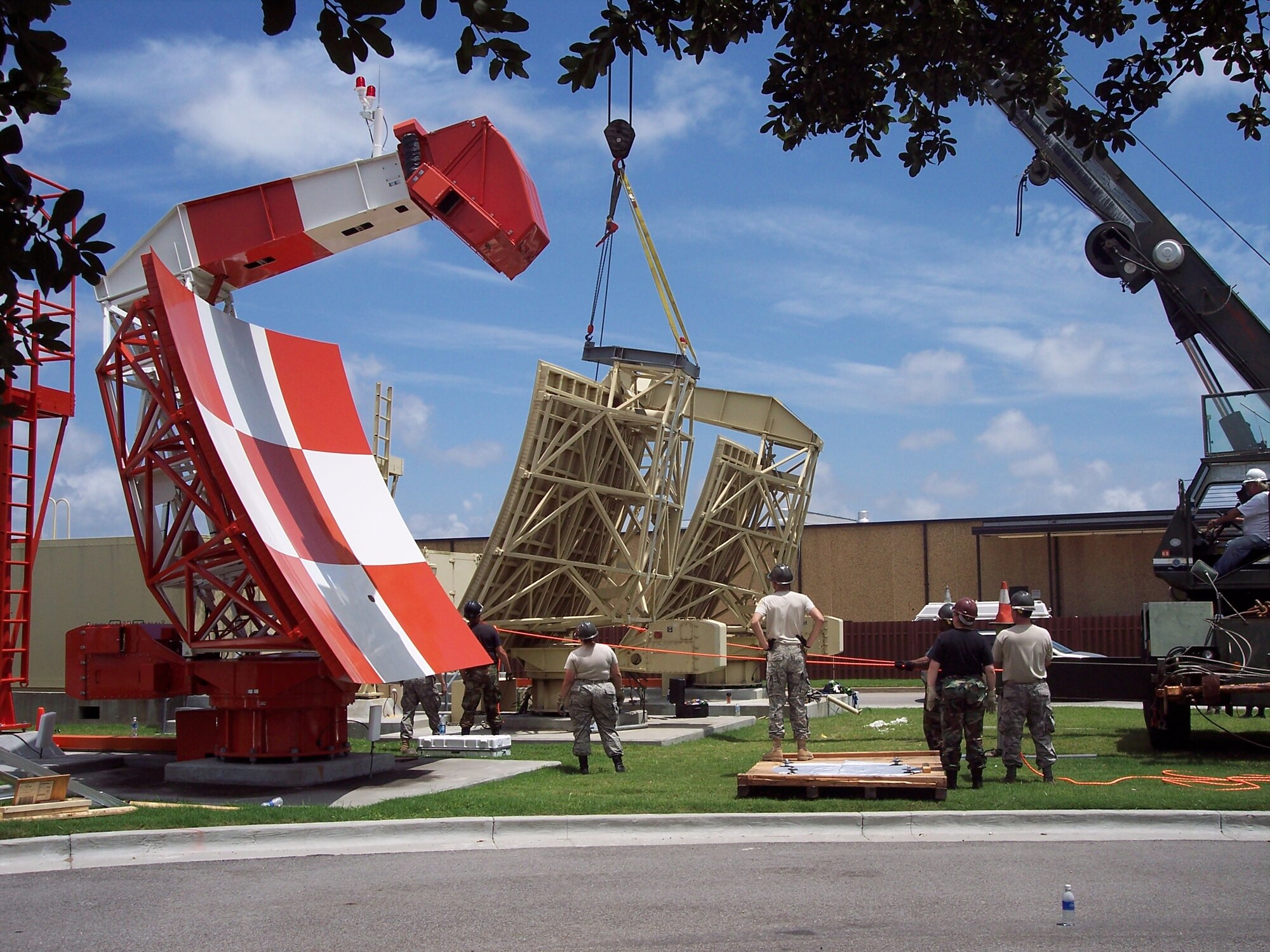 The GPN-22 radar antenna located between the supply warehouse and Cody Hall is lowered to be dismantled for shipment to Tobyhanna Army Depot in Pennsylvania.  The depot, a major element of the U.S. Army Communications-Electronics Command, is the largest full-service electronics maintenance facility in the Department of Defense.  (U.S. Air Force photo by Dale Riggins)
