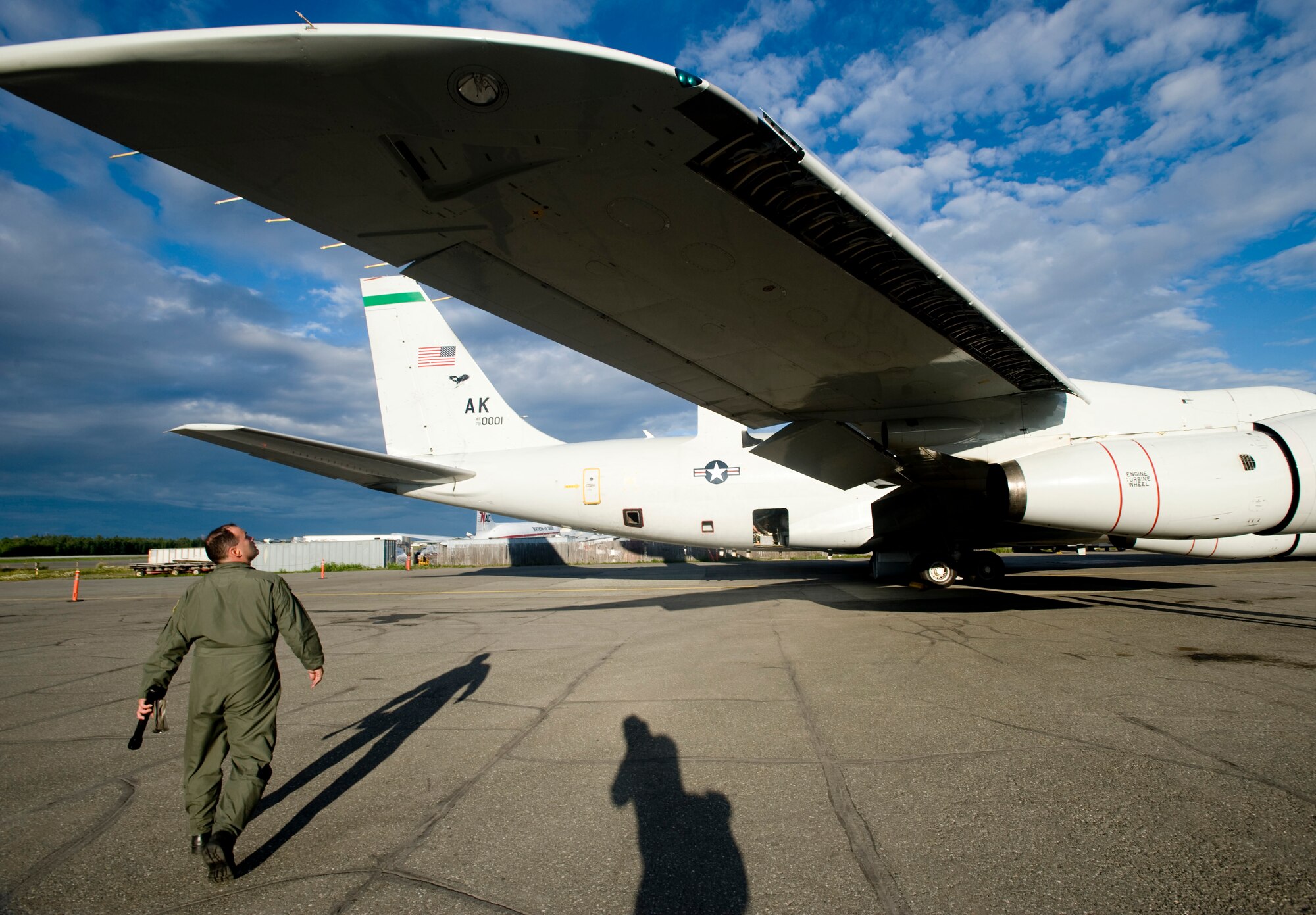 KULIS AIR NATIONAL GUARD BASE, Alaska -- Master Sgt. Scotty Shinall, 3rd Operations Group, inspects wings of an E-3 Sentry prior to take off August 7. The 962nd Airborne Air Control Squadron has been temporarily using Kulis' runways due to the closure of Elmendorf's main runway. The squadron has been assigned to Elmendorf since October 1992. (U.S. Air Force photo/Senior Airman Jonathan Steffen)