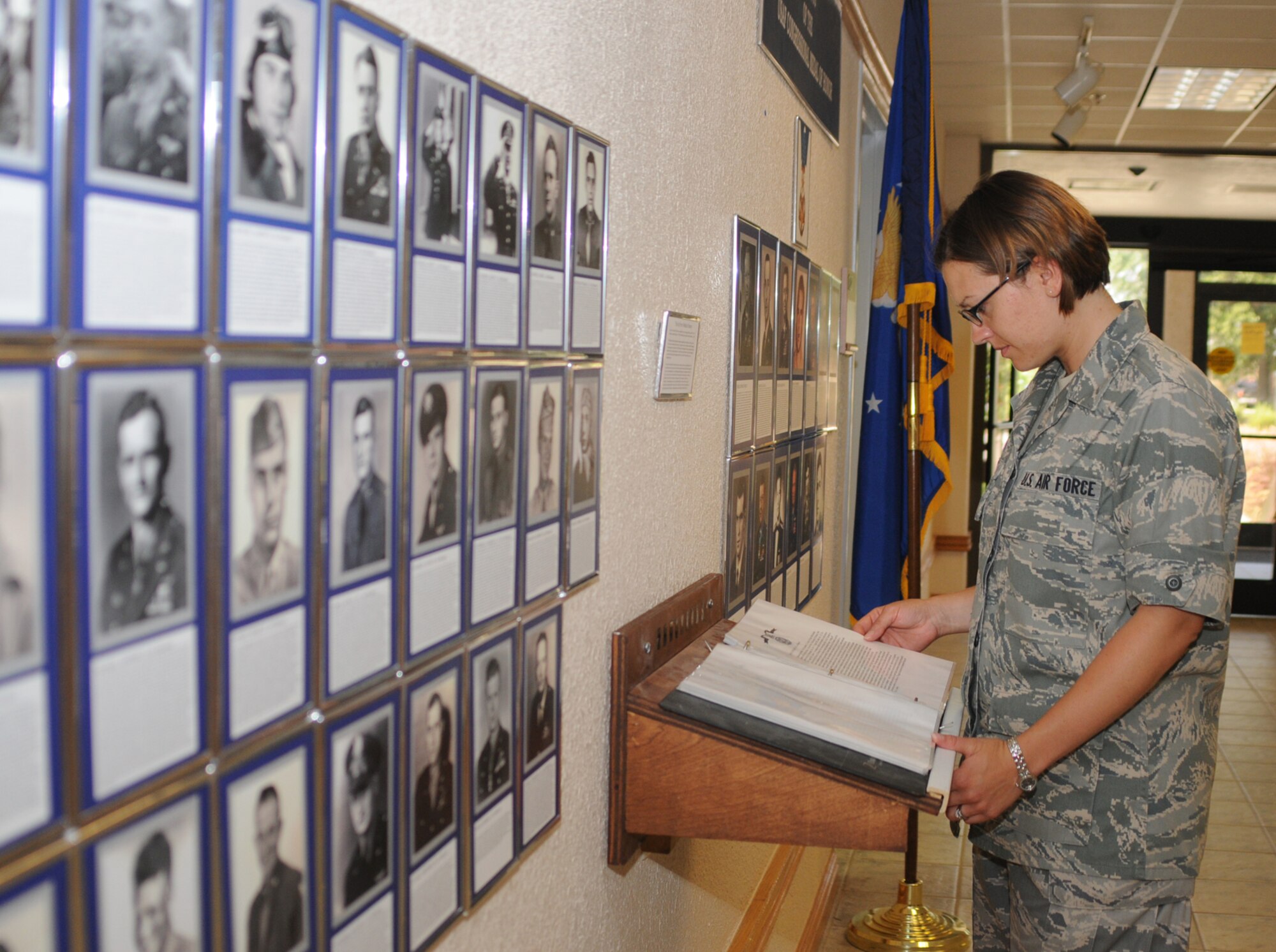 Airman Basic Nichole Stone, a student in the 335th Training Squadron, views a display recently set up by retiree volunteers in the lobby of Sablich Center.  The display features photographs of Air Force members who’ve received the Medal of Honor, both before and after a separate Air Force Medal of Honor was established Nov. 1, 1965.  The Medal of Honor is the nation’s highest military honor awarded by Congress for risk of life in combat beyond the call of duty.  (U.s, Air Force photo by Kemberly Groue)