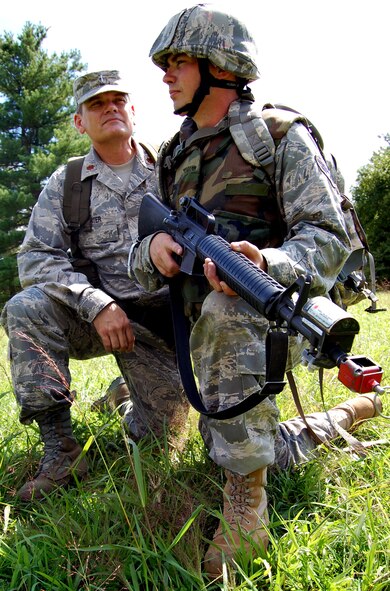 Chaplain (Maj.) Thomas Porter, U.S. Air Force Expeditionary Center chaplain, works with Senior Airman Roger Rhymer, a chaplain assistant from the 20th Fighter Wing Chapel, Shaw Air Force Base, S.C., during training in patrolling and tactics for the Air Force Advanced Contingency Skills Training Course on a Fort Dix, N.J., range Aug. 12, 2008.  Chaplain Porter serves as the lead chapel cadre for expeditionary training of chaplains and chaplain assistants from around the Air Force.  (U.S. Air Force Photo/Tech. Sgt. Scott T. Sturkol)