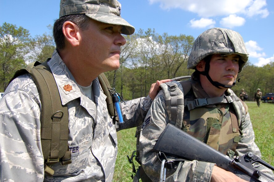 Chaplain (Maj.) Thomas Porter, U.S. Air Force Expeditionary Center chaplain, works with Senior Airman Roger Rhymer, a chaplain assistant from the 20th Fighter Wing Chapel, Shaw Air Force Base, S.C., during training in patrolling and tactics for the Air Force Advanced Contingency Skills Training Course on a Fort Dix, N.J., range Aug. 12, 2008.  Chaplain Porter serves as the lead chapel cadre for expeditionary training of chaplains and chaplain assistants from around the Air Force.  (U.S. Air Force Photo/Tech. Sgt. Scott T. Sturkol)