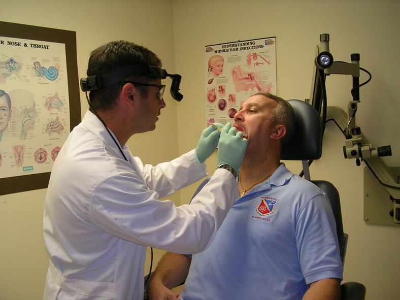 Dr. (Maj) Peter G. Michaelson, Chief Otolaryngologist, doing a pre-procedure exam of Captain Basler.  (U.S. Air Force photo)