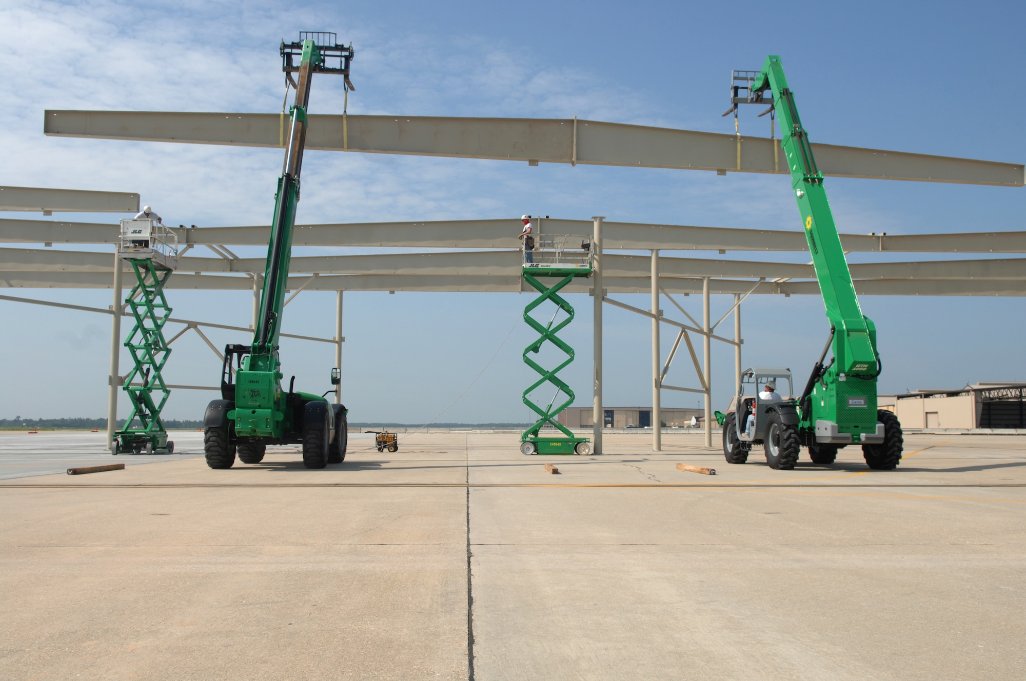 SHAW AIR FORCE BASE, S.C. -- Iron workers with Agate Construction from Mason, Ariz., use their equipment to lift a 5,800 pound rafter to the frame of a multi-million dollar aircraft shelter to improve flightline Airmen's safety, well-being and job environment along with providing aircraft protection from weather elements, Aug. 7. The shelters are scheduled for completion in February 2009. (U.S. Air Force photo/Staff Sgt. Nathan Bevier)