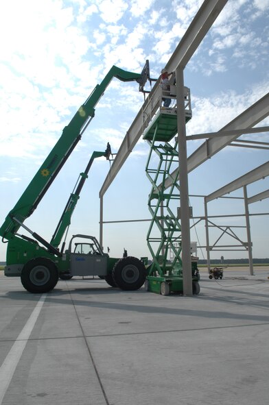 SHAW AIR FORCE BASE, S.C. -- Randy Rice, Agate Construction iron worker from Mason, Ariz., secures a knee brace to the frame of a multi-million dollar aircraft shelter to improve flightline Airmen's safety, well-being and job environment along with providing aircraft protection from weather elements, Aug. 7. The shelters are scheduled for completion in February 2009. (U.S. Air Force photo/Staff Sgt. Nathan Bevier)