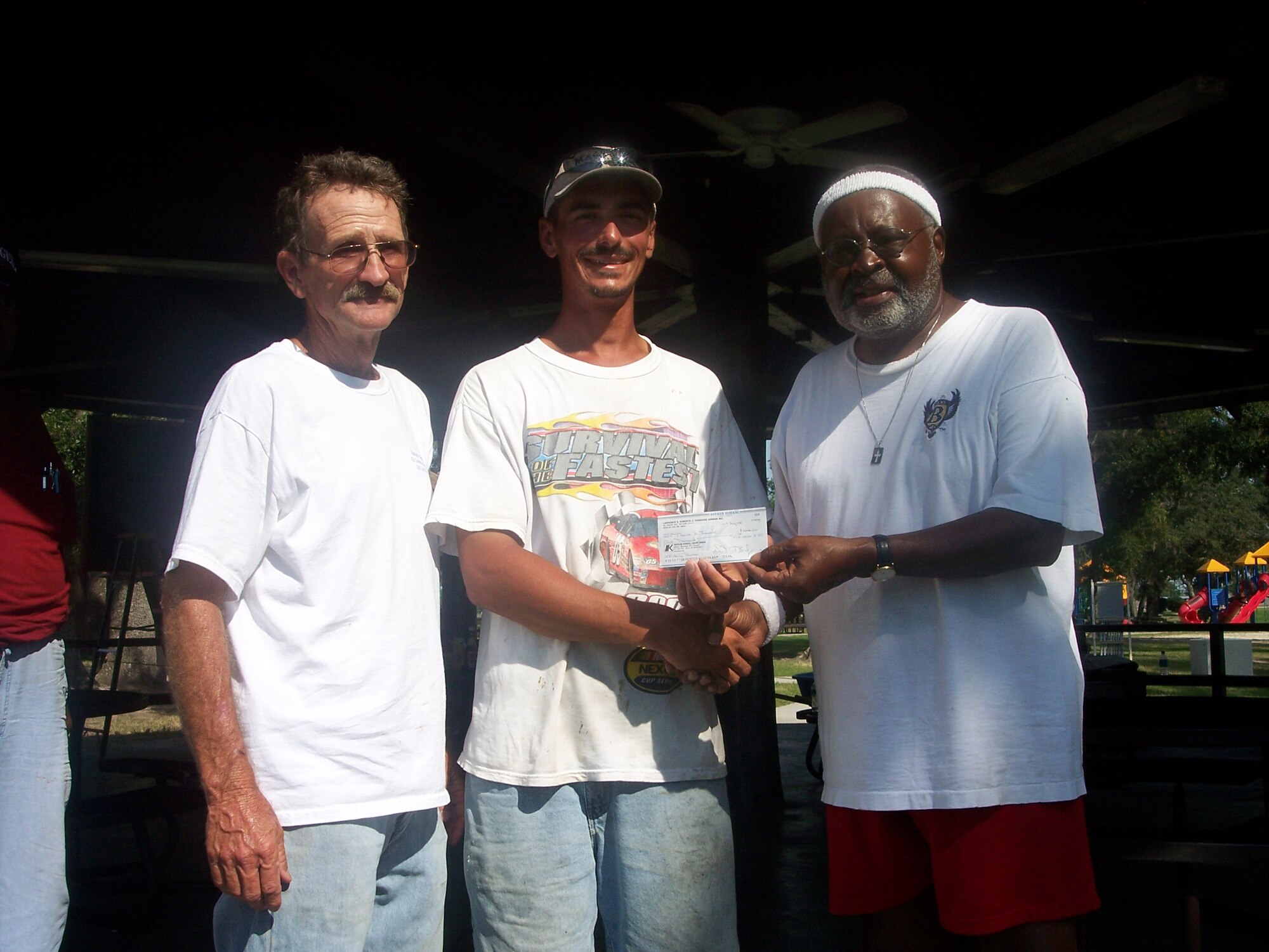 Charles Bowers, president of the Lawrence E. Roberts Gulf Coast Chapter of the Tuskegee Airmen Association presents Tommy Fournier with a $1,000 check for placing first in the Black Drum Fishing Rodeo held at Keesler Air Force Base Aug. 8-9.  Mr. Fournier caught three fish weighing a total of 126.4 pounds during the two-day tournament sponsored by the organization.  Mr. Fournier also received top honors for the largest black drum caught, which weighed 45.7 pounds.
(Courtesy photo)
