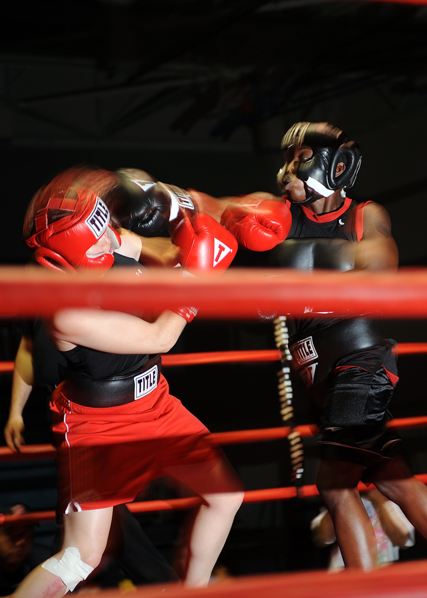 Tech. Sgt. Genese Williams, 49th Materiel Maintenance Support Squadron lands a punch on her opponent, Army 2nd Lt. Emma Taylor during their boxing match at Fort Bliss Army Post in El Paso, Texas,  July 25. The bout was an exhibition due to the differences in weight class. (U.S Air Force photo/ Airman 1st Class DeAndre Curtiss)
