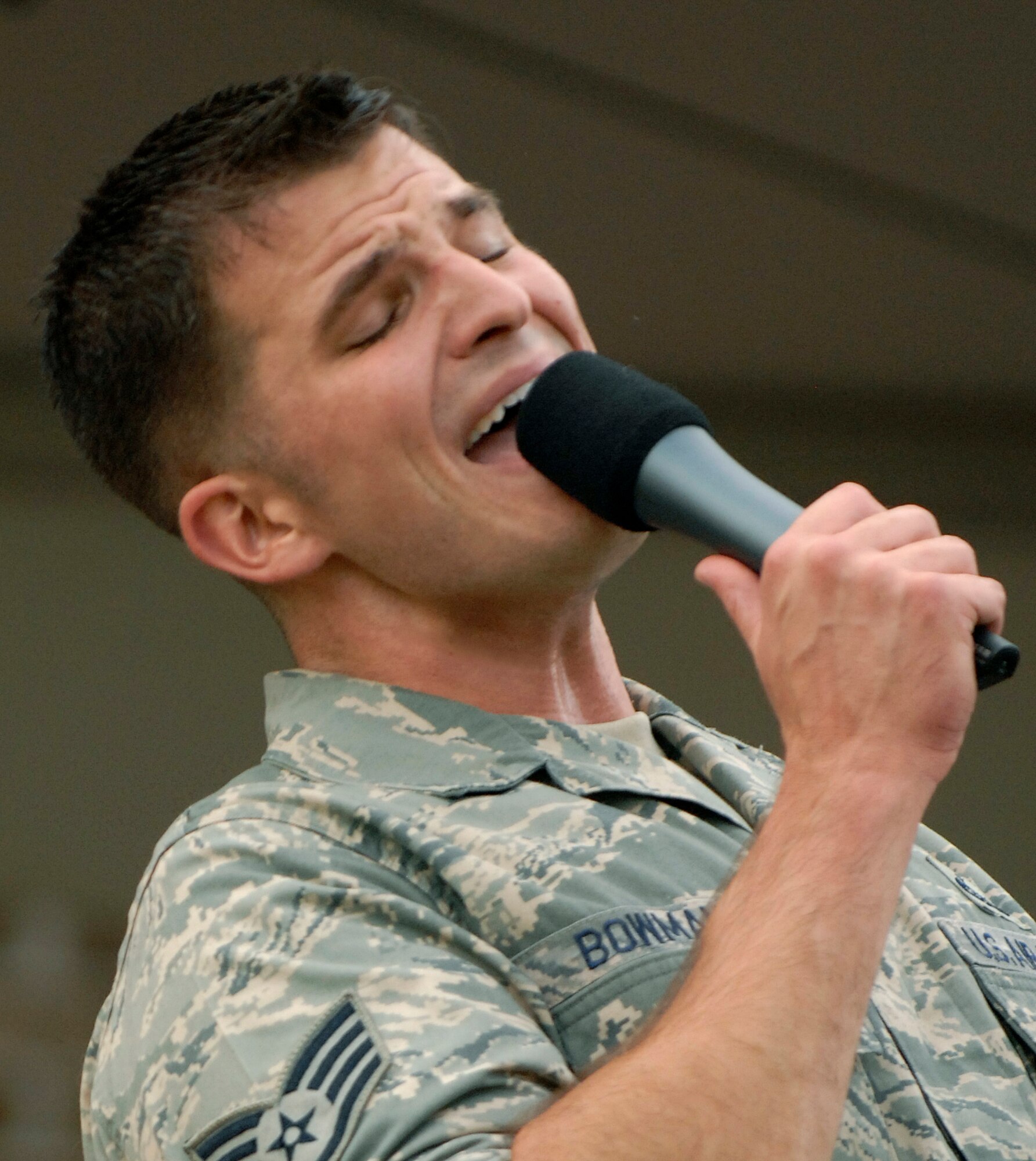 LANGLEY AIR FORCE BASE, Va. -- Staff Sgt. Craig Bowman, Air Combat Command Heritage of America Band vocalist, sings to the crowd during a concert in Yorktown, Va. Aug. 12.  The ACC Heritage of America Band performs throughout the summer to connect with the local community and are scheduled to perform again on Aug. 19.  (U.S. Air Force photo/Senior Airman Vernon Young)