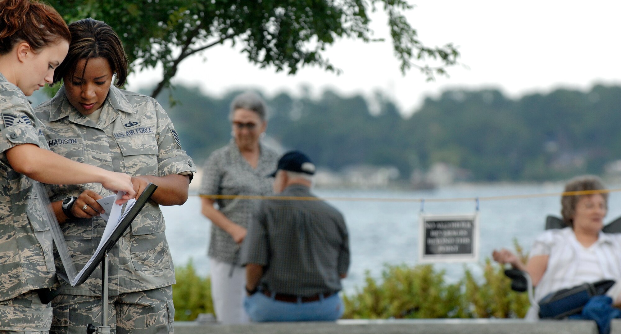 LANGLEY AIR FORCE BASE, Va. -- Tech. Sgt. Becky Wolf and Staff Sgt. Natalie Madison,  Air Combat Command Heritage of America Band vocalists, organize music before a summer concert in Yorktown, Va. Aug. 12.  The ACC Heritage of America Band performs to connect with the local community during the summer months and is scheduled to perform in Yorktown again on Aug. 19.   (U.S. Air Force photo/Senior Airman Vernon Young)