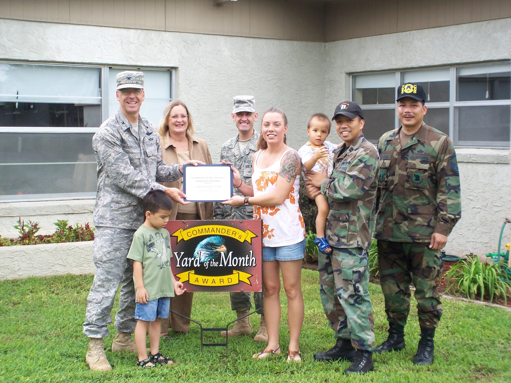 Col. Bruce McClintock, 96th Air Base Wing commander, presents Capt. Gordon Deng and his wife, Christina, a certificate of award in the Yard of the Month competition. The Dengs also received two $25 gift cards. (USAF photo by Timothy Crews) 