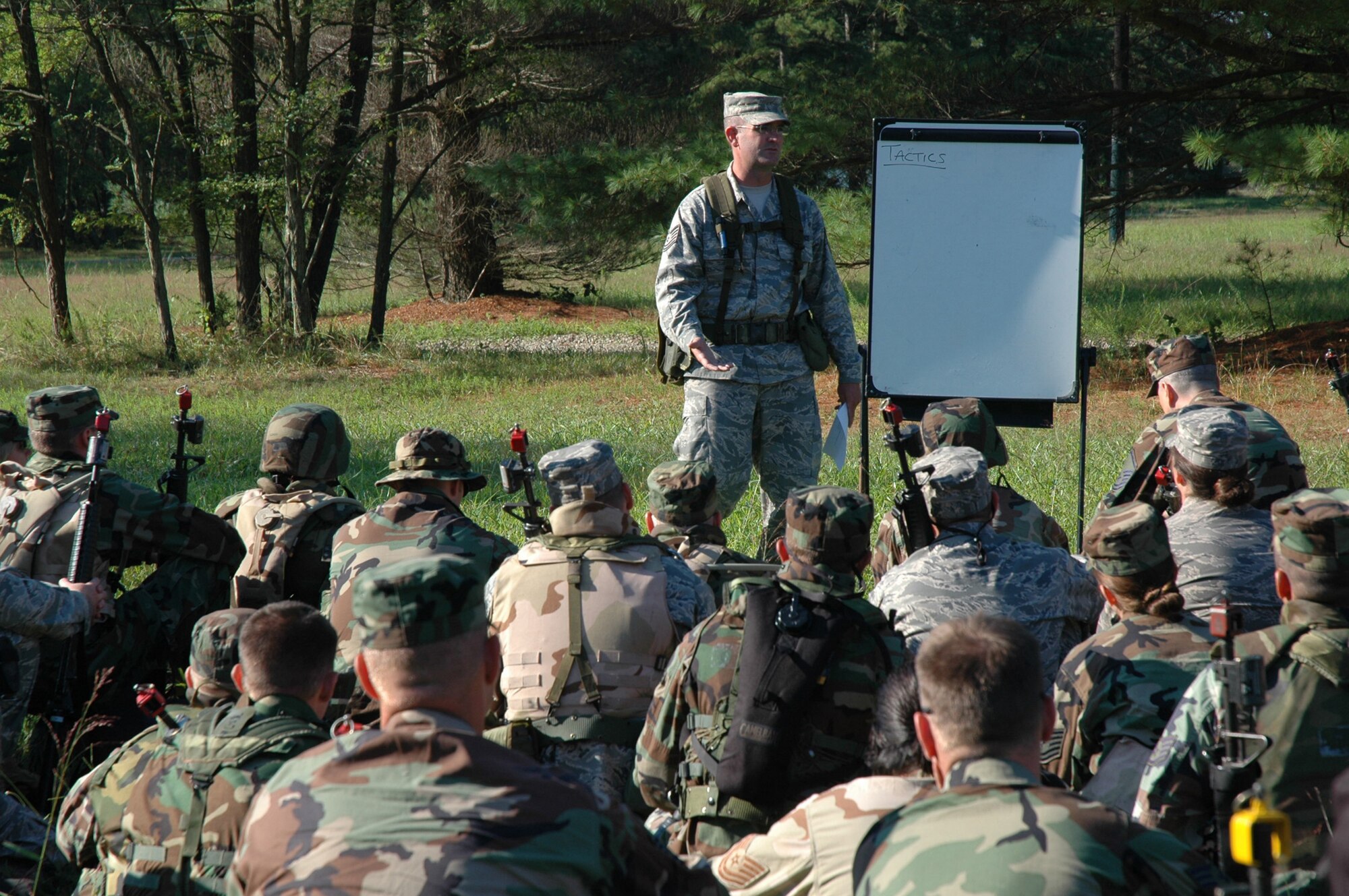 Tech. Sgt. William Lipsett, 421st Combat Training Squadron, talks to students in the Advanced Contingency Skills Training Course about basic combat patrolling and tactics on a range on Fort Dix, N.J., Aug. 12, 2008.  The course, taught by the U.S. Air Force Expeditionary Center's 421st CTS, prepares Airmen for upcoming deployments.  (U.S. Air Force Photo/Staff Sgt. Paul R. Evans)