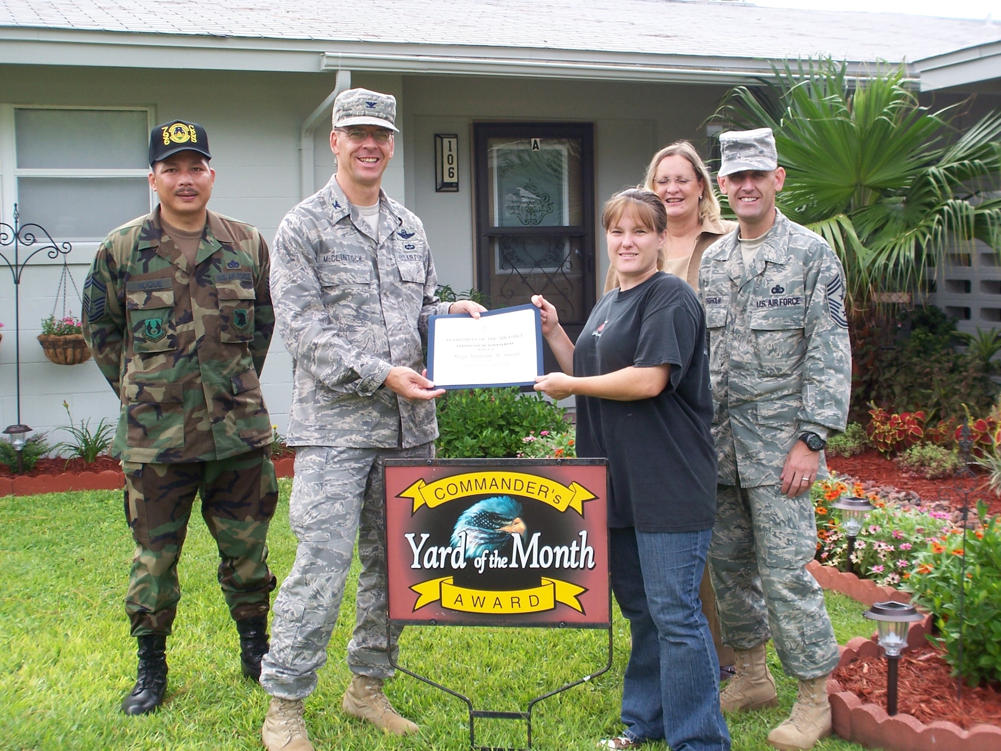 Col. Bruce McClintock, 96th Air Base Wing commander, presents Becky Smith a certificate of award in the Yard of the Month competition. Her husband, Master Sgt. William Smith, is currently deployed.  Mrs. Smith also received two $25 gift cards. (USAF photo by Timothy Crews) 