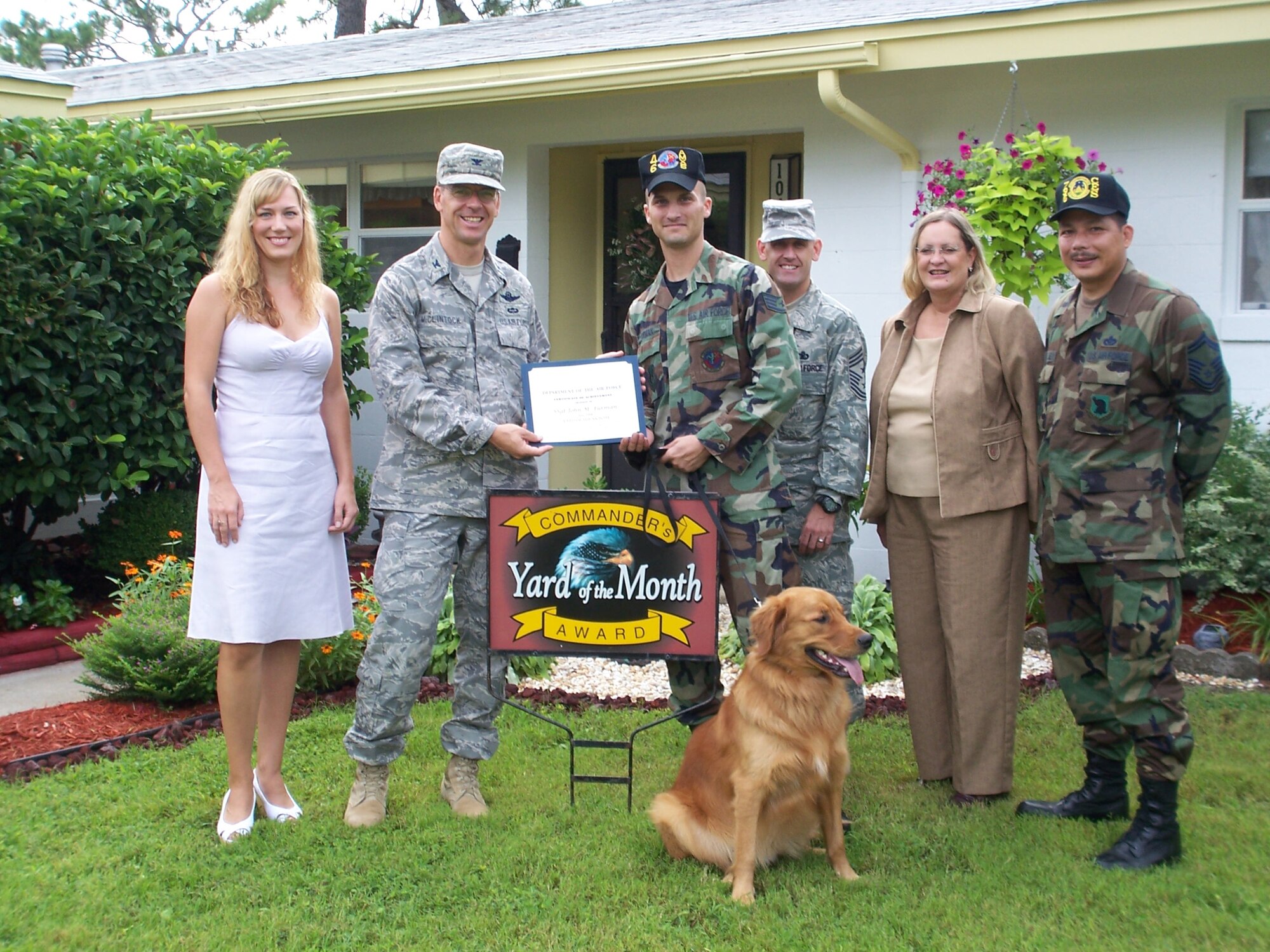 Col. Bruce McClintock, 96th Air Base Wing commander, presents  Staff Sgt. John Furman and his wife, Kristen,a  certificate of award in the Yard of the Month competition. The Furmans also received two $25 gift cards. (USAF photo by Timothy Crews)