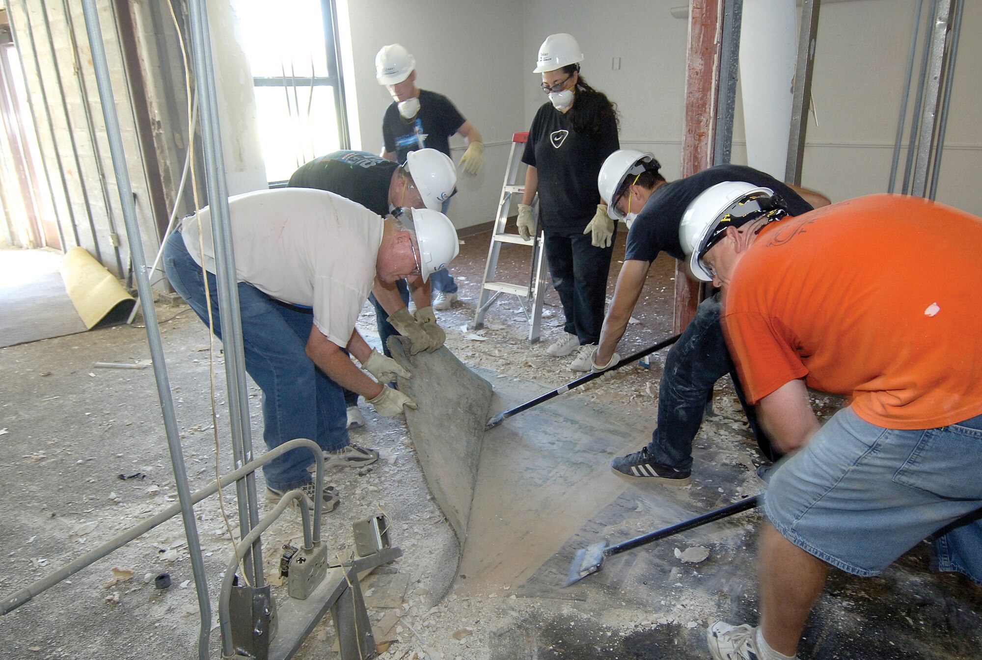 Volunteers start renovations to turn a few Loop Hall dorm rooms and a day room into the Latte’ Lounge by fall.  Clockwise from left are; Tom Taylor, Base Chapel volunteer; Chief Master Sgt. John Dunham, 552nd Maintenance Squadron; Senior Master Sgt. Rich Waters, 72nd Medical Operations Squadron; Master Sgt. Christina Bodden, 72nd Medical Group; Staff Sgt. Justin Underdown, 964th Airborne Air Control Squadron; and Bill Hanson, 552nd Air Control Wing Requirements Office.  A Base Chapel-sponsored project, the lounge in Bldg. 5913 will offer Airmen a positive environment to meet on weekends for snacks and specialty coffees and coffee drinks.  The lounge will have Wii, other digital games plus traditional games like pool and foosball.  HD televisions, an internet café’ and special nights of music and karaoke are also planned.  According to Chaplain (Capt.) Kelly Stahl, everything will be free for Airmen. Volunteers are still needed to continue with remodeling efforts.  Please contact the Base Chapel, 734-2111 if interested. (Air Force photo/Margo Wright)
