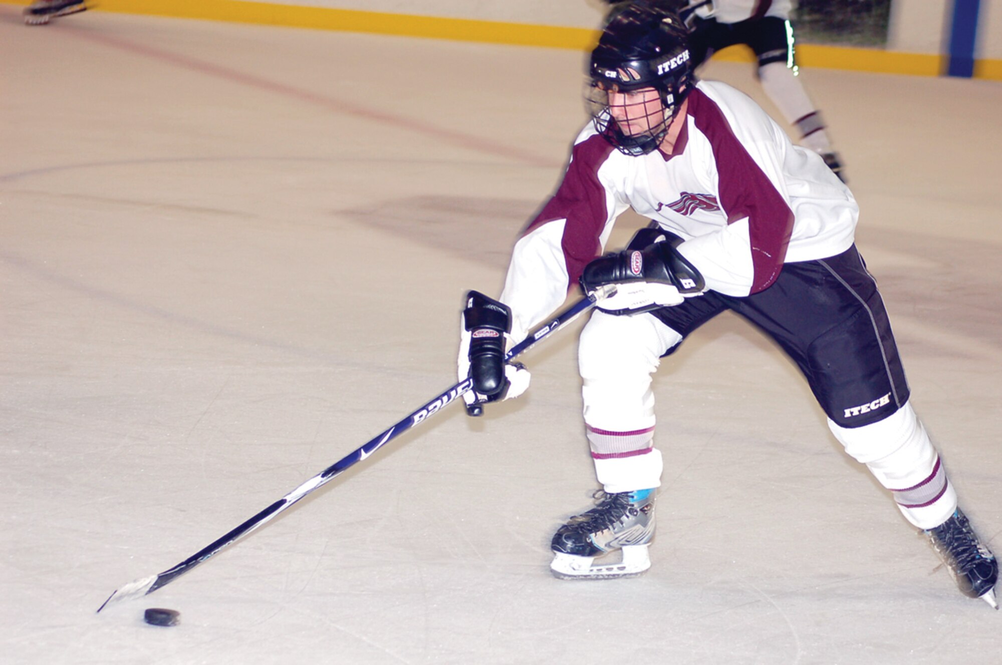 Tinker Hawks I defenseman Dave McClean carries the puck into the Knights’ zone in the second period of an Aug. 10 game at the Blazers Ice Centre. The Hawks won 6-2.(Air Force photo/John Banks)

