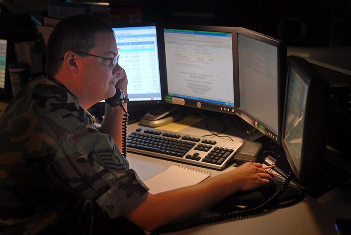 Tech. Sgt. Brian Dillo checks on the status of a KC-135 Stratotanker supporting a local C-17 training mission on base Aug. 13. The 437th Airlift Wing Command Post is responsible for disseminating command control information that is vital to leadership and other  agencies on base. Sergeant Dillo is the 437 AW/CP NCO in charge of operational control functions. (U.S. Air Force photo/Airman 1st Class Melissa White)