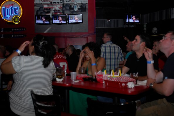 MINOT AIR FORCE BASE, N.D. – A group of fight fans react to the action during the Ultimate Fighting Championship which aired at J.R. Rockers here Aug. 9.  The mixed martial art sport is normally a pay-per-view event. However, thanks to Air Combat Command sponsorship, the event was free to club members. (U.S. Air Force photo by Airman 1st Class Jesse Lopez)
