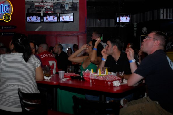 MINOT AIR FORCE BASE, N.D. – A group of fight fans react to the action during the Ultimate Fighting Championship which aired at J.R. Rockers here Aug. 9.  The mixed martial art sport is normally a pay-per-view event. However, thanks to Air Combat Command sponsorship, the event was free to club members. (U.S. Air Force photo by Airman 1st Class Jesse Lopez)
