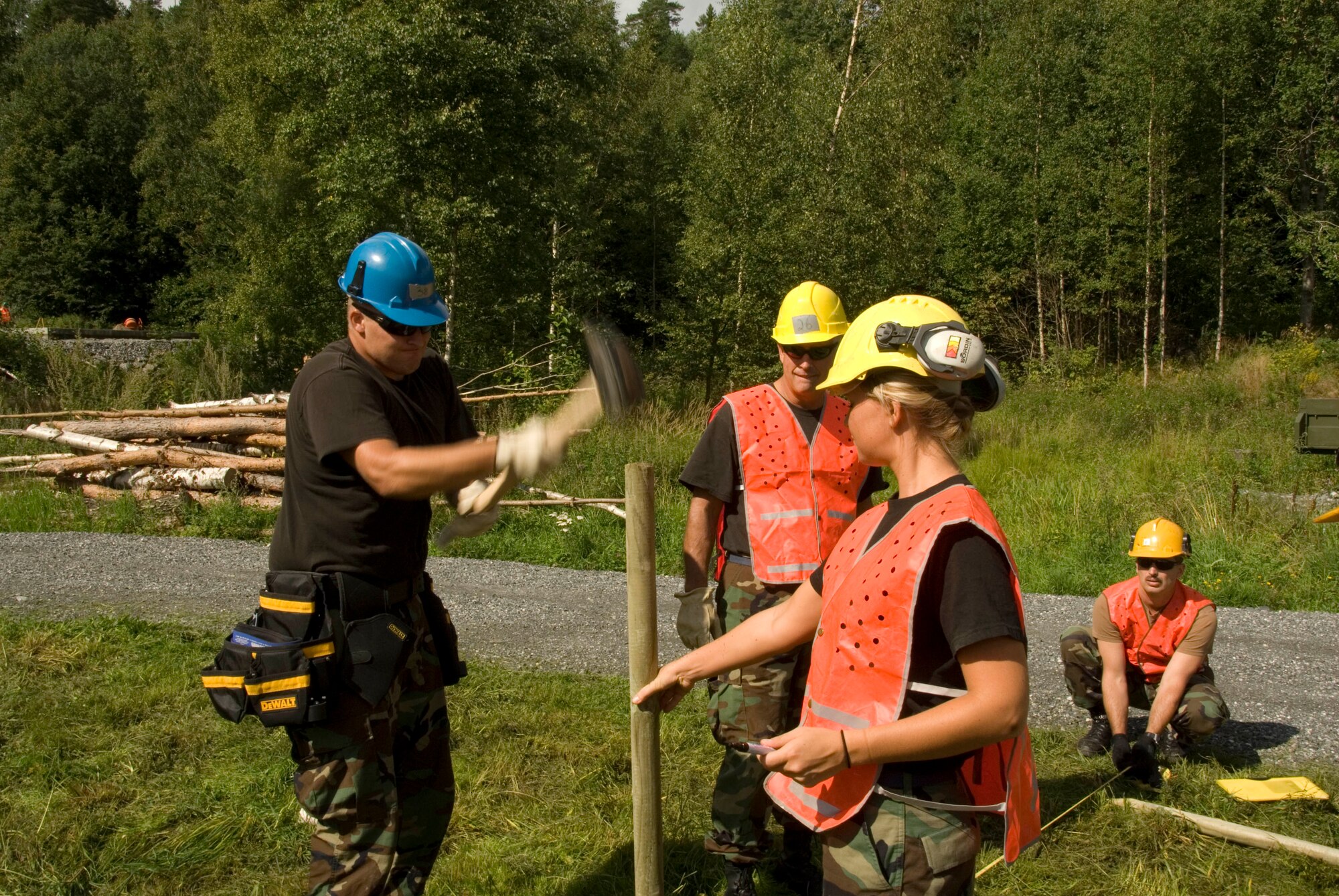August 11, 2008 Rygge, Air Force Base, Norway- 

(L to R) SSgt Adam Conlon, MSgt Howard Beyer, SrA Amanda Prescott and MSgt Vance Choquette, construct a fence for the military dog training grounds.
Members of the Iowa Air National Guard, 185th Air Refueling Wing (ARW), Civil Engineering (CE) in Sioux City, Iowa, deployed for training to Rygge Air Force Base, Norway, in support of Operation Impeccable Glove 2008. The engineering mission is a joint effort with the Norwegian Military Academy at Rygge Air Force Base, constructing numerous projects for the military and community.

Official Air Force Photo By: SSgt. Oscar M. Sanchez-Alvarez



