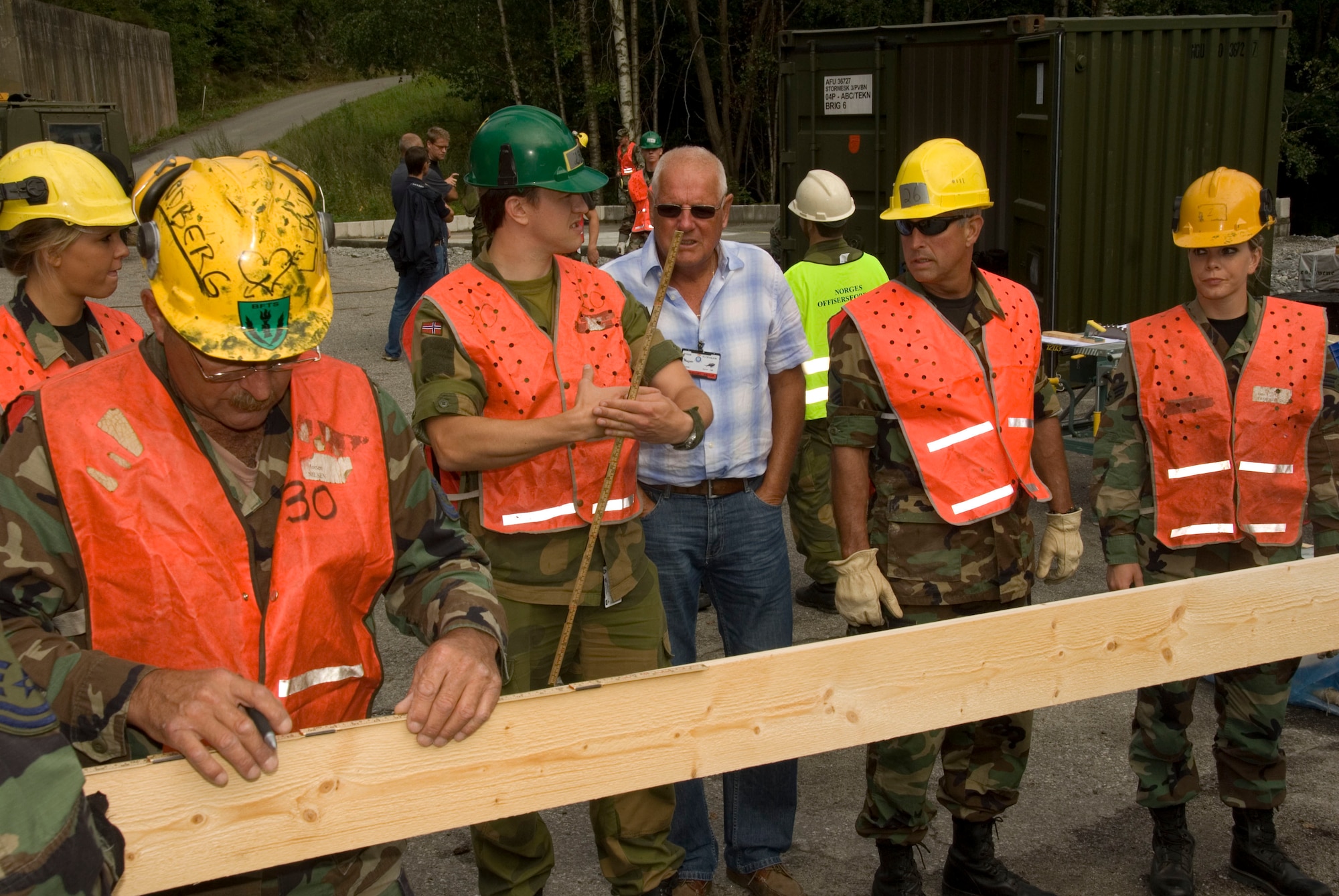 August 11, 2008 Rygge, Air Force Base, Norway- 

2dLt Helge Vallano from the Norwegian Military Academy and Bjorn Hermansen a retired engineering teacher, explain to the Airman of the 185th Civil Engineers the construction plans of a garage that is being built at Rygge Air Force Base.
Members of the Iowa Air National Guard, 185th Air Refueling Wing (ARW), Civil Engineering (CE) in Sioux City, Iowa, deployed for training to Rygge Air Force Base, Norway, in support of Operation Impeccable Glove 2008. The engineering mission is a joint effort with the Norwegian Military Academy at Rygge Air Force Base, constructing numerous projects for the military and community.

Official Air Force Photo By: SSgt. Oscar M. Sanchez-Alvarez
