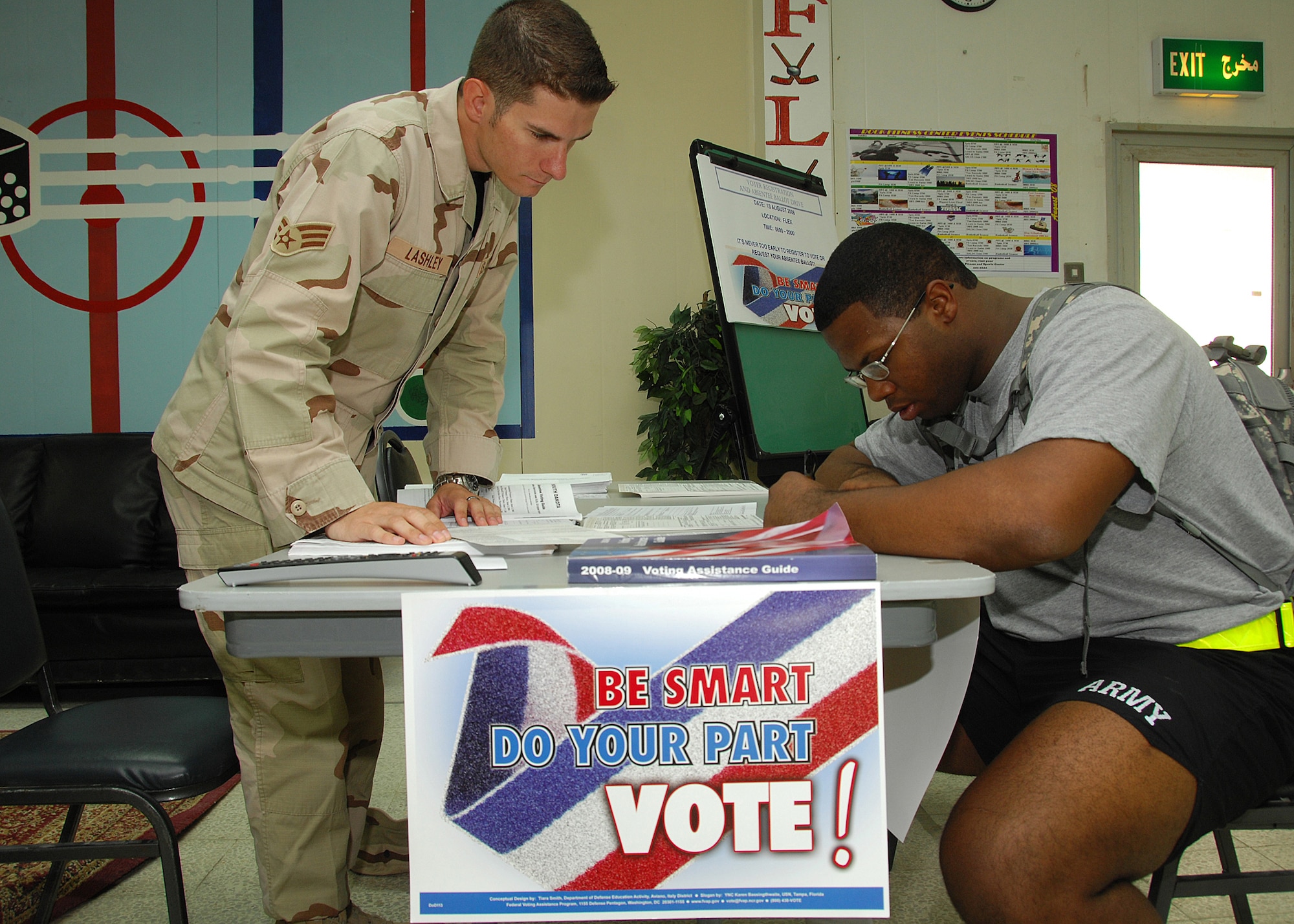 SOUTHWEST ASIA -- Senior Airman Brian Lashley, 386th Expeditionary Civil Engineer Squadron voting assistance officer, helps Army Private 1st Class Chris Williams register to vote on Aug. 13 at a base in Southwest Asia. The 386th Air Expeditionary Wing held a base-wide voter registration and absentee ballot drive to increase servicemember participation in November's general election. Airman Lashley is deployed from Eglin Air Force Base, Fla. (U.S. Air Force photo/Tech. Sgt. Raheem Moore)