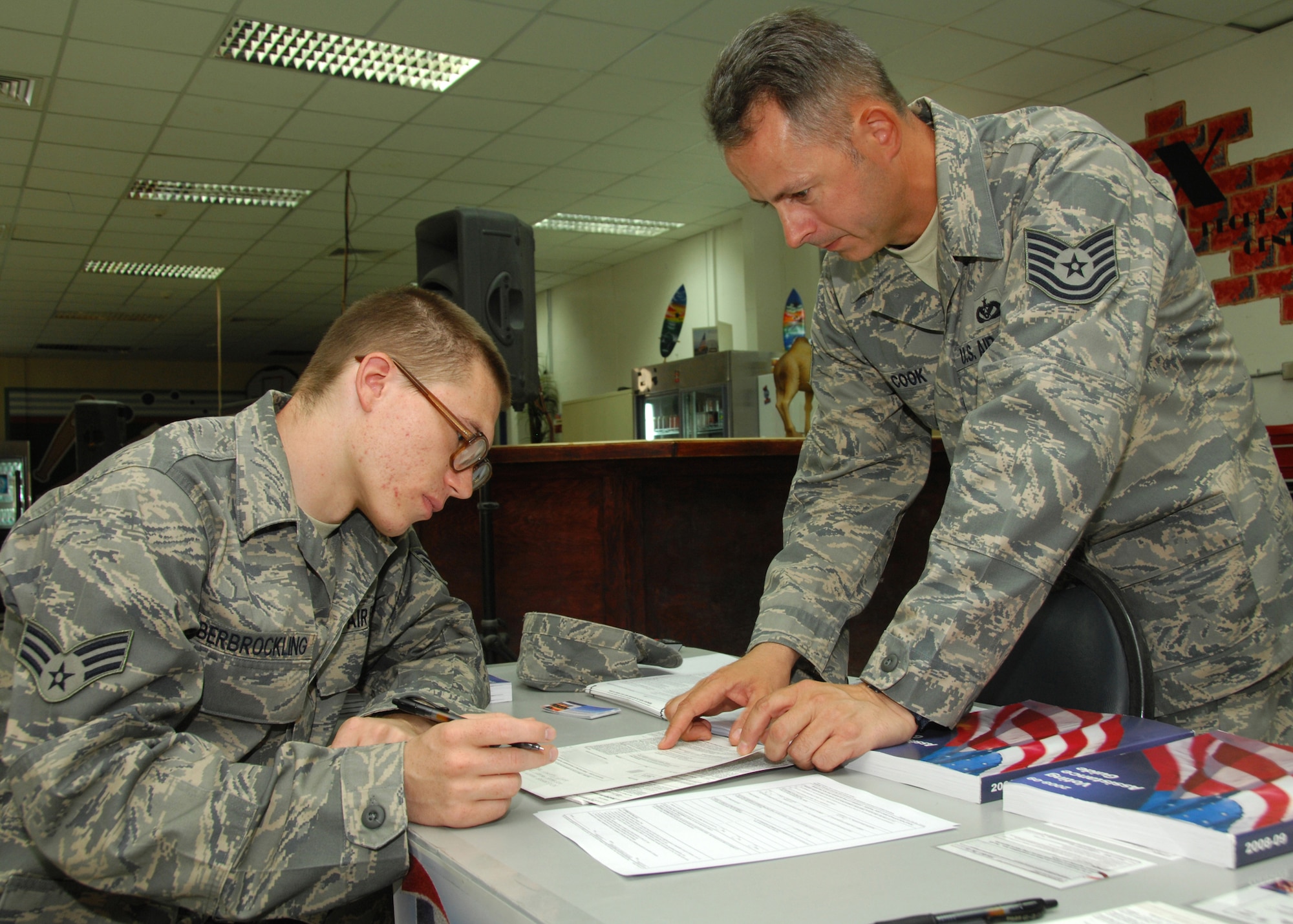 SOUTHWEST ASIA -- Tech. Sgt. Michael Cook, 386th Expeditionary Civil Engineer Squadron voting assistance officer, helps Senior Airman Michael Oberbrockling register to vote on Aug. 13 at a base in Southwest Asia. The 386th Air Expeditionary Wing held a base-wide voter registration and absentee ballot drive to increase servicemember participation in November's general election. This will be Airman Oberbrockling's first time voting in the general election. Sergeant Cook is deployed from Royal Air Force Lakenheath, United Kingdom. Airman Oberbrockling is deployed from Travis Air Force Base, Calif. (U.S. Air Force photo/Tech. Sgt. Raheem Moore)