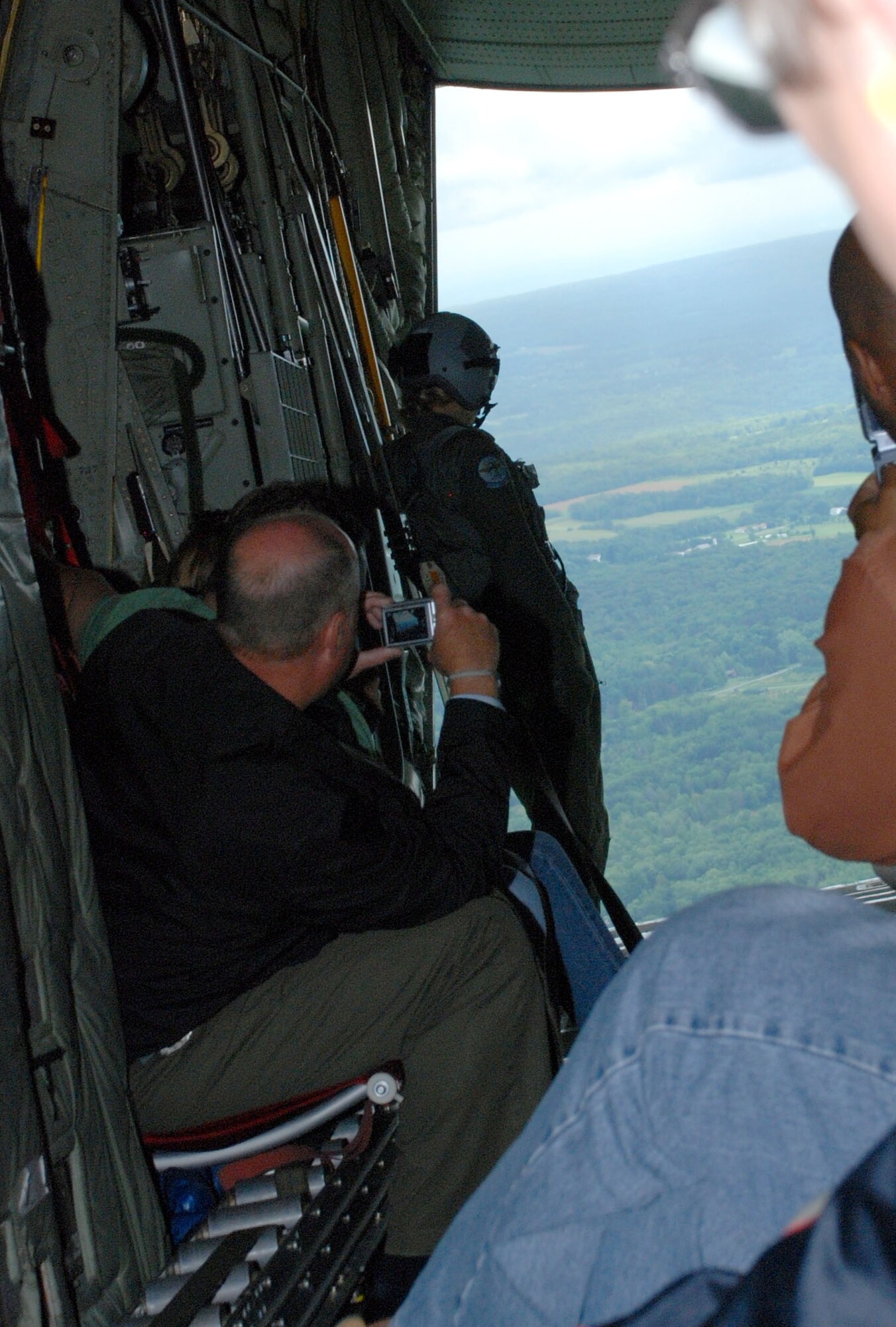 Senior Airman Tiffany Seager, loadmaster, 914th AW, keeps eye on the rear of the C-130. Pilots from the 107th AW position the aircraft for premium viewing of local attractions such as the ?Falls? Orchard Stadium and the Niagara River.(Air Force Photo/ Master Sgt. Paul Brundage)