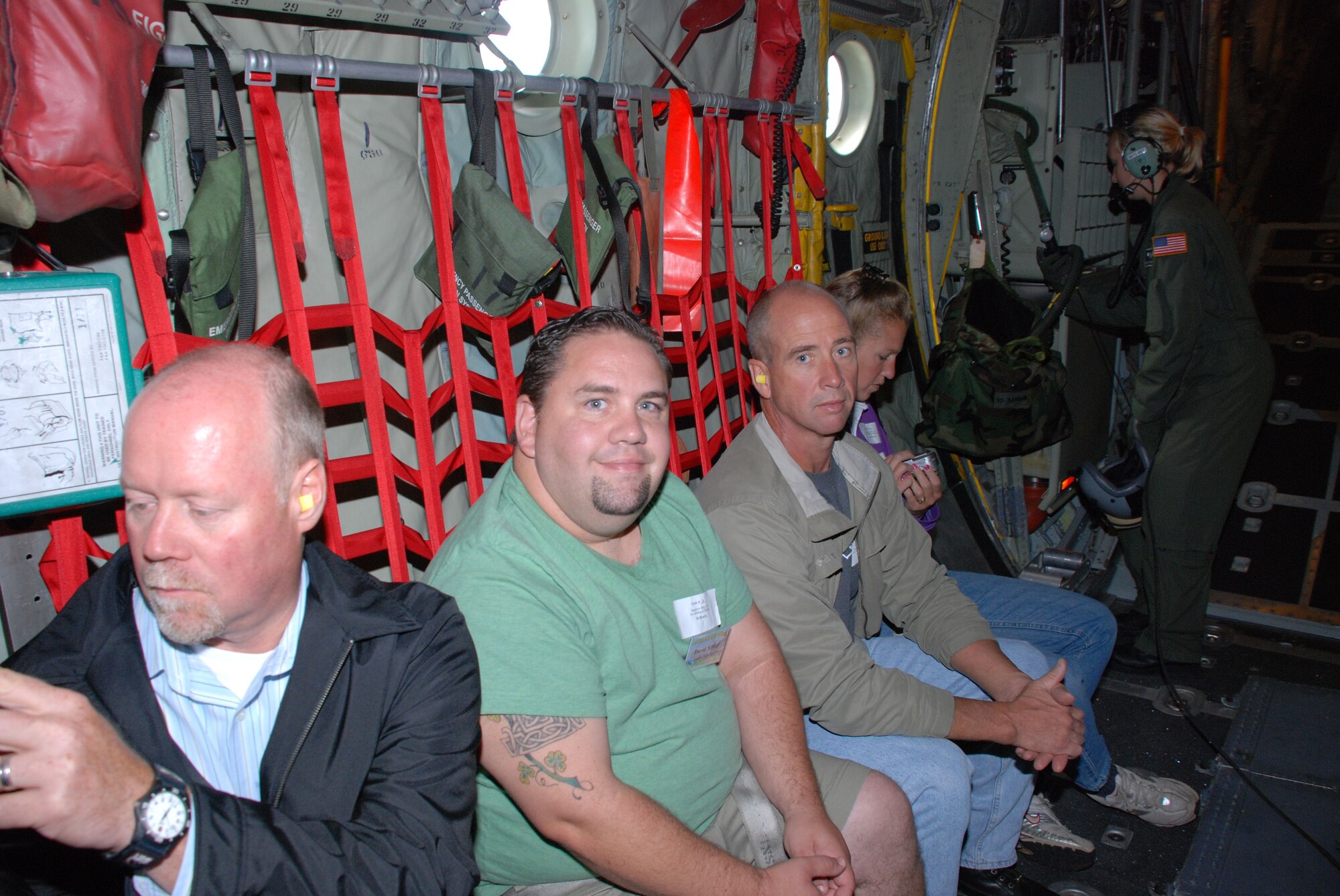 Civilian bosses buckle in, check their cameras and prepare for take off. (Air Force Photo/ Master Sgt. Paul Brundage)