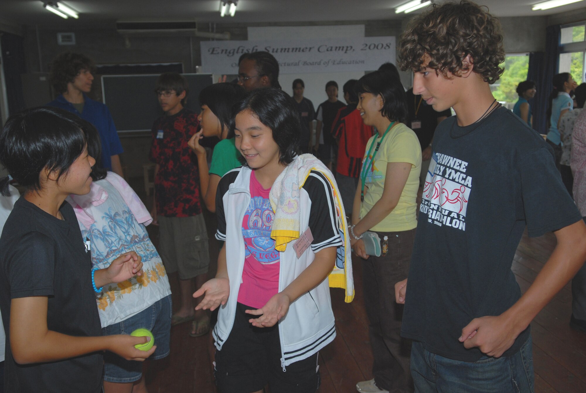 Okinawan and American students play games during English Summer Camp activities.
(U.S. Air Force photo/Junko Kinjo)