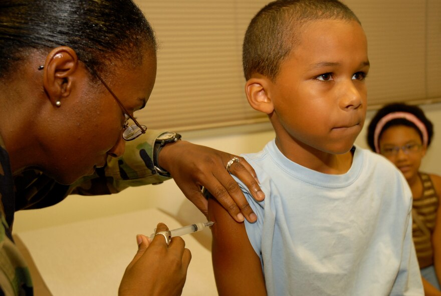 Marques Ward, 8, receives a shot by Senior Amn Alecia Peel at the Kadena Immunizations clinic.  All PACAF medical facilities are affected by the recall of the Hib vaccine and are currently experiencing an extreme shortage of the vaccination. 
(U.S. Air Force photo by Staff Sergeant Angelique M. Perez)