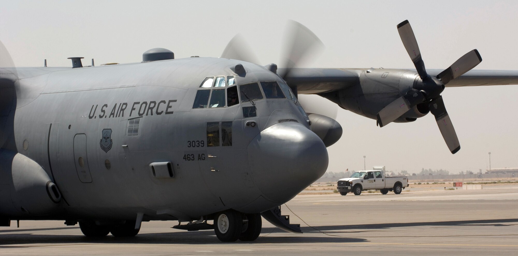 JOINT BASE BALAD, Iraq --A C-130 Hercules cargo aircraft starts up its engines before taxiing to the runway here Aug. 12. The C-130 provides heavy airlift throughout the entire U.S. Central Command area of responsibility regardless of runway conditions or weather, day or night. This C-130 is deployed from the 314th Airlift Wing at Little Rock Air Force Base, Ark. (U.S. Air Force photo/Tech. Sgt. Erik Gudmundson)